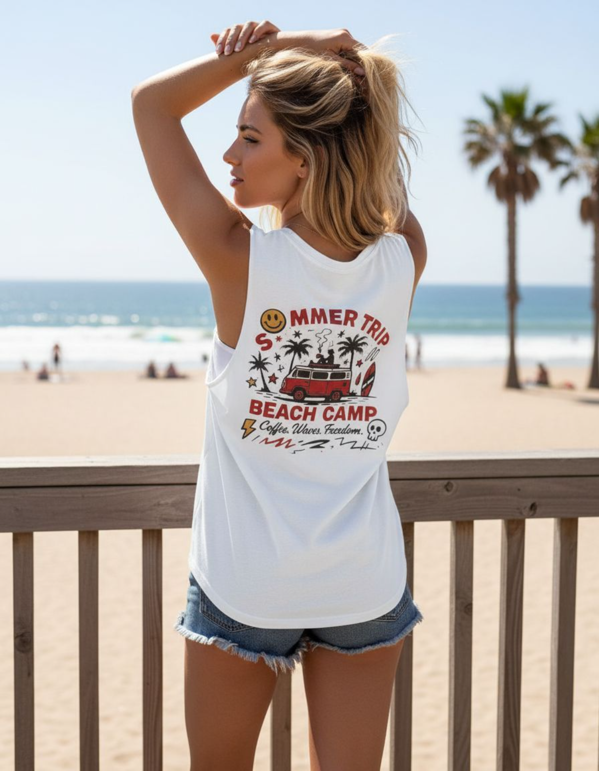 Woman wearing Taily Summer Trip Tank, a streetwear graphic tank, with bold red seaside design at the beach.