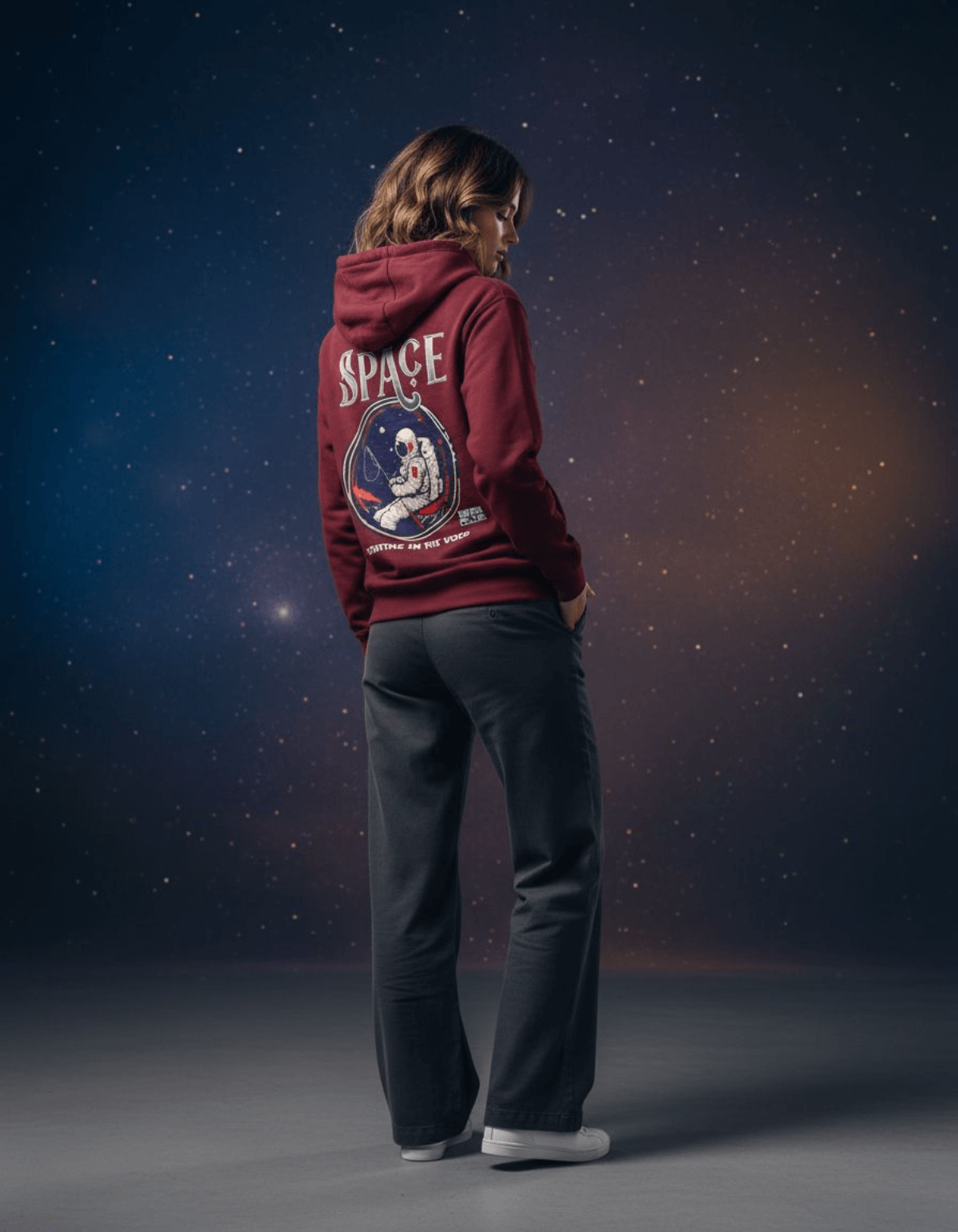 Model wearing Taily Space Club Streetwear Graphic Hoodie in burgundy against a cosmic background.