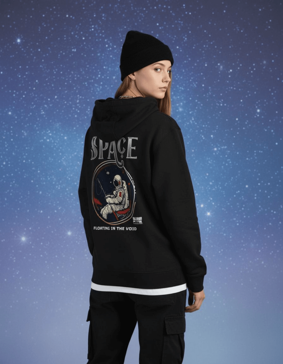 Taily Space Club Streetwear Graphic Hoodie in black worn by model, featuring astronaut design and phrase 'Floating in the Void'.