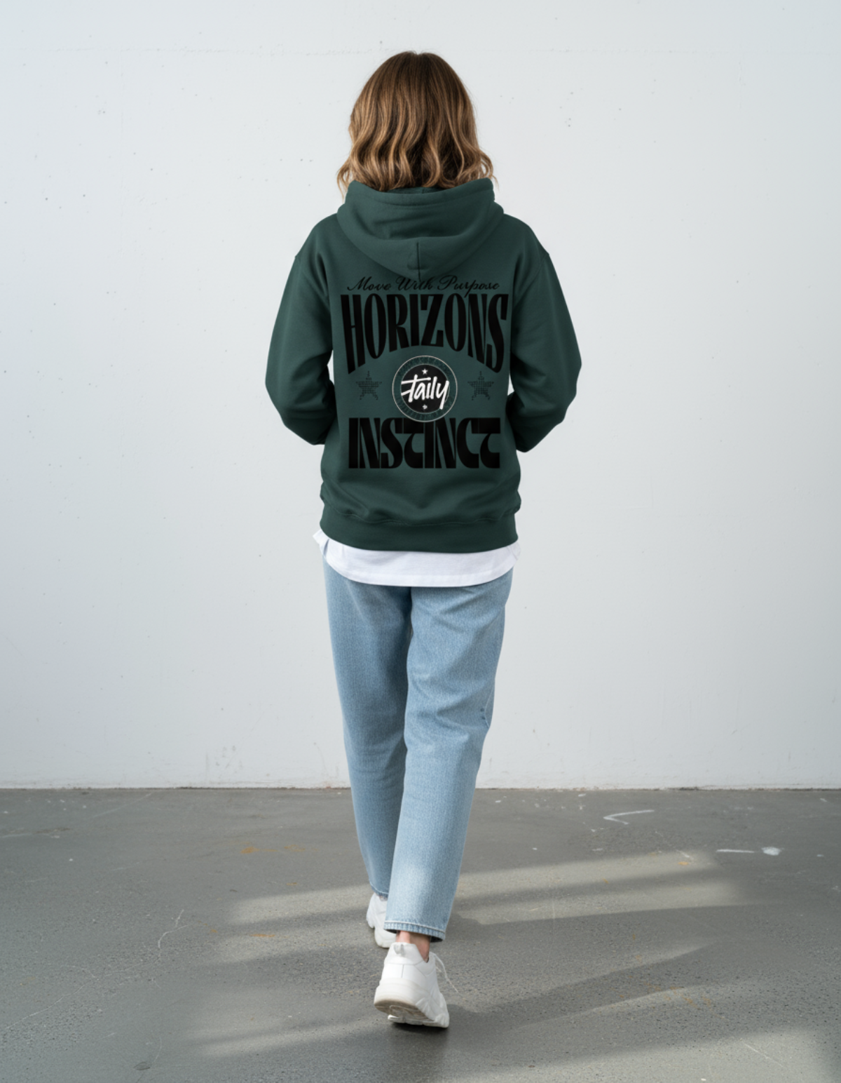 Model wearing the Taily Horizons Instinct Hoodie in Sports Green, showcasing the back design with motivational text.