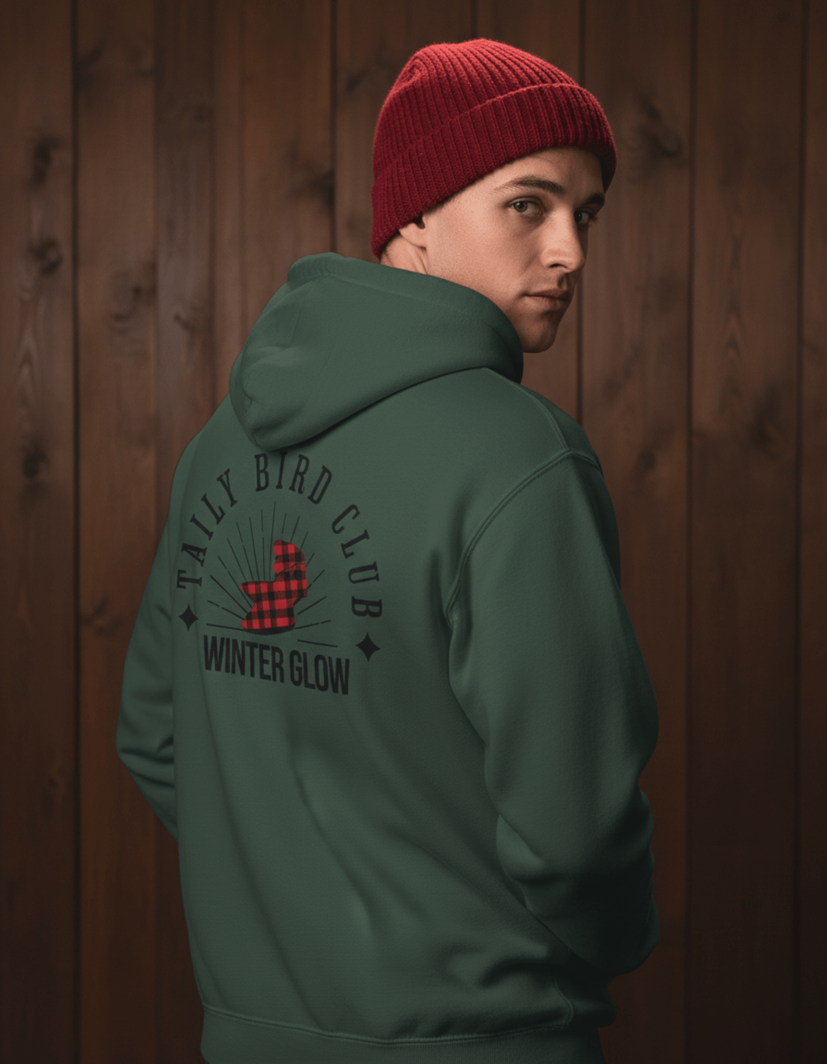Taily Bird Club Winter Glow Hoodie – Alpine Green worn by a model showcasing the back design with vintage lettering.