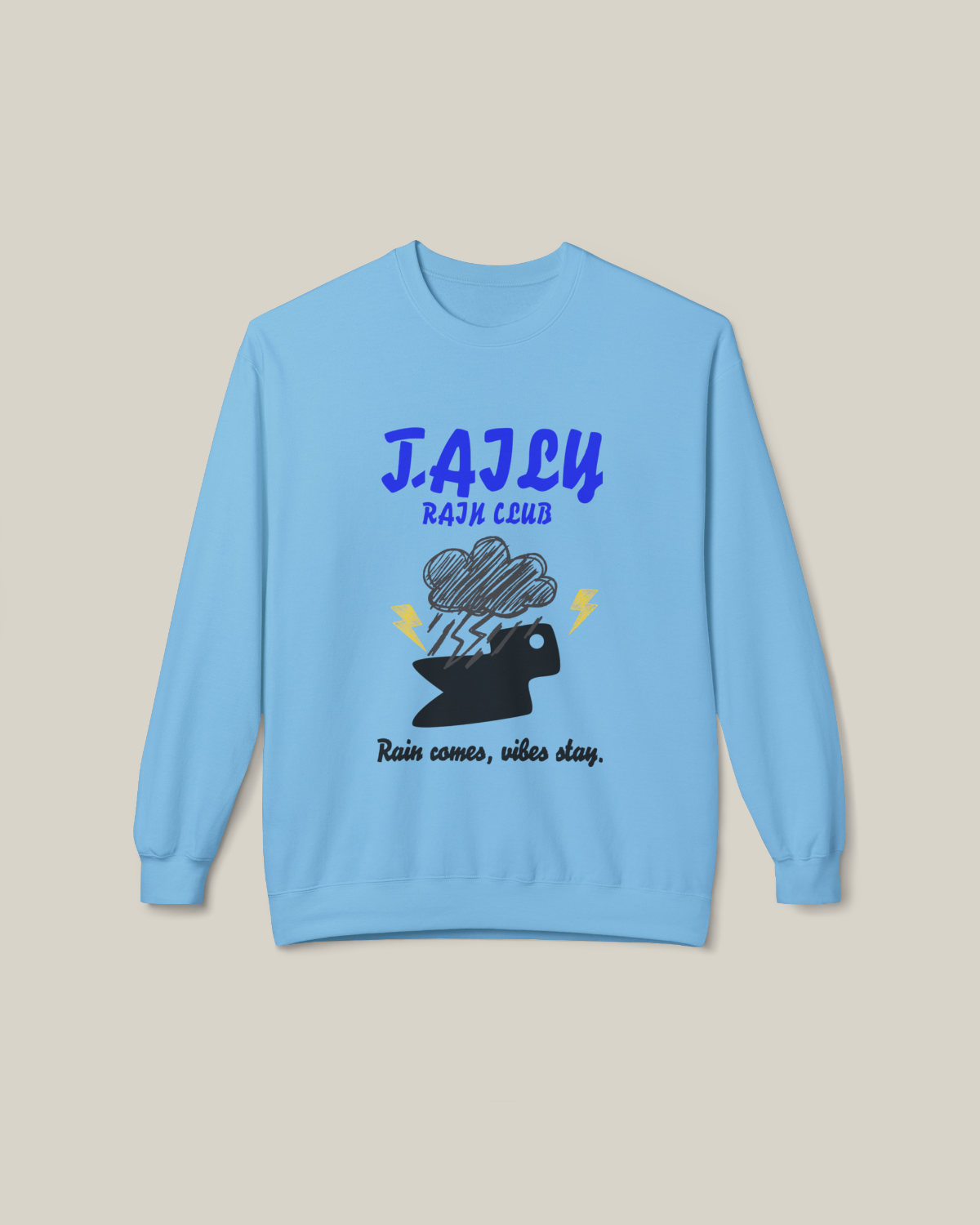 Taily Rain Club sweatshirt in sky blue with cloud and lightning graphic, featuring text 'Rain comes, vibes stay.'