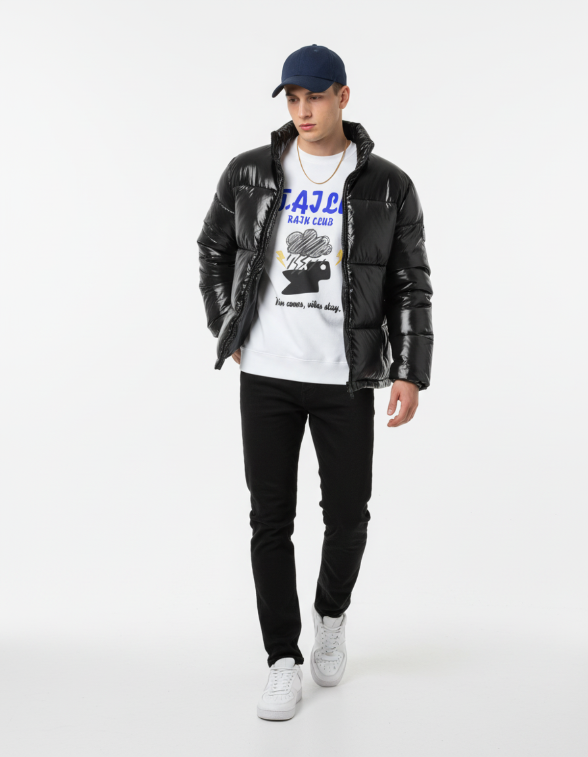 Model wearing Taily Rain Club sweatshirt in white, paired with a black puffer jacket and black jeans, showcasing streetwear style.