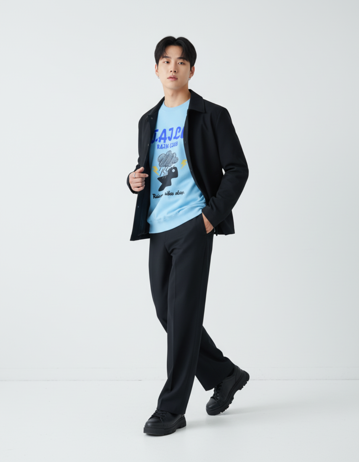 Model wearing Taily Rain Club sweatshirt in Sky with a black jacket and pants, showcasing a casual style.