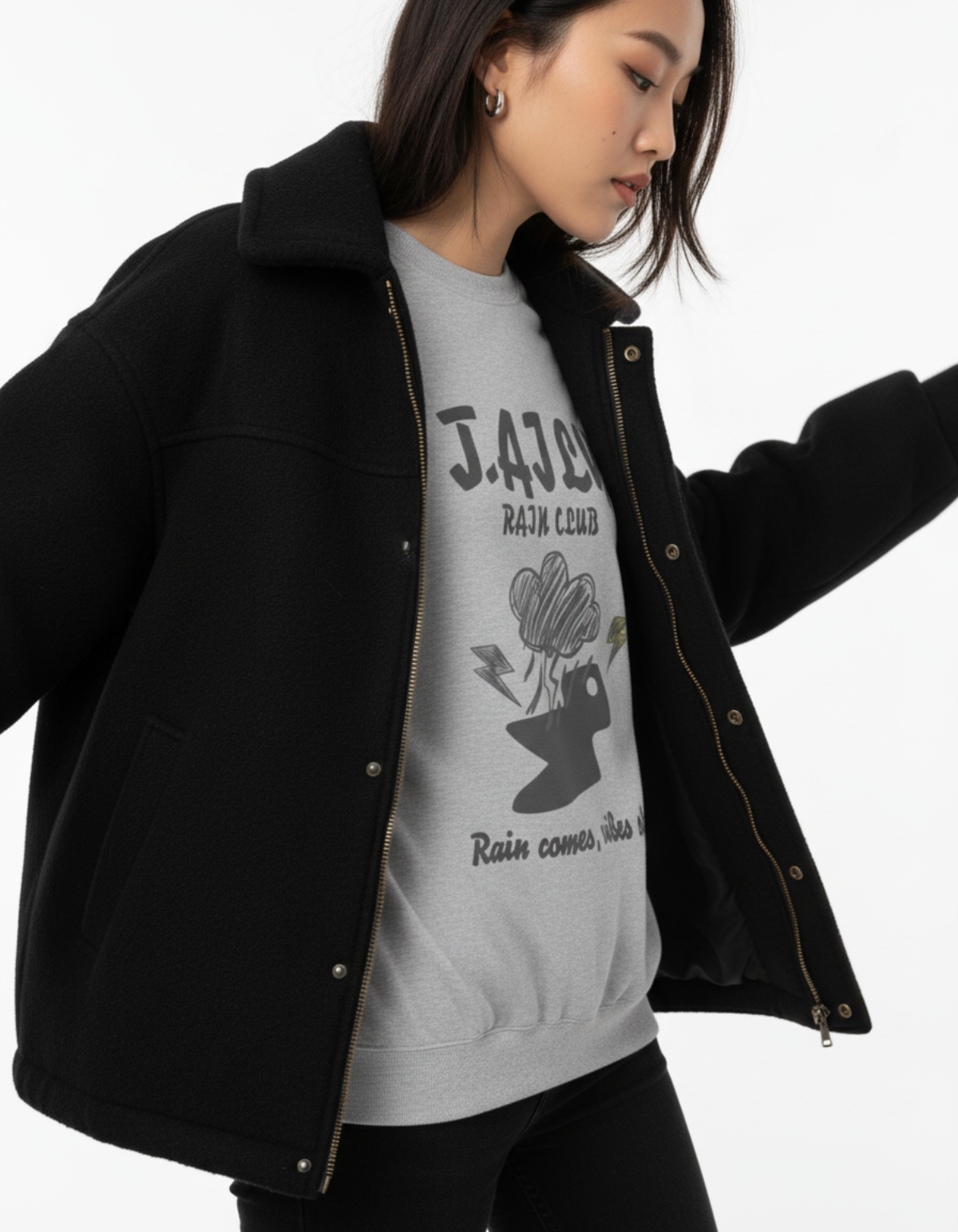 Model wearing Taily Rain Club sweatshirt in Sport Grey with cloud and lightning design.