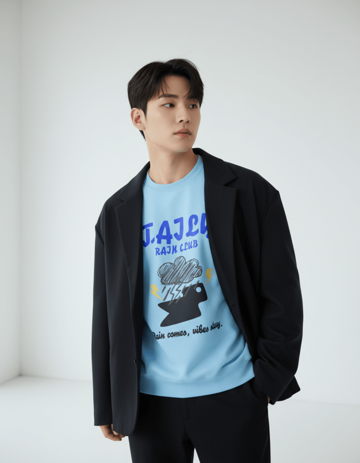 Model wearing Taily Rain Club sweatshirt in Sky with cloud and lightning design.