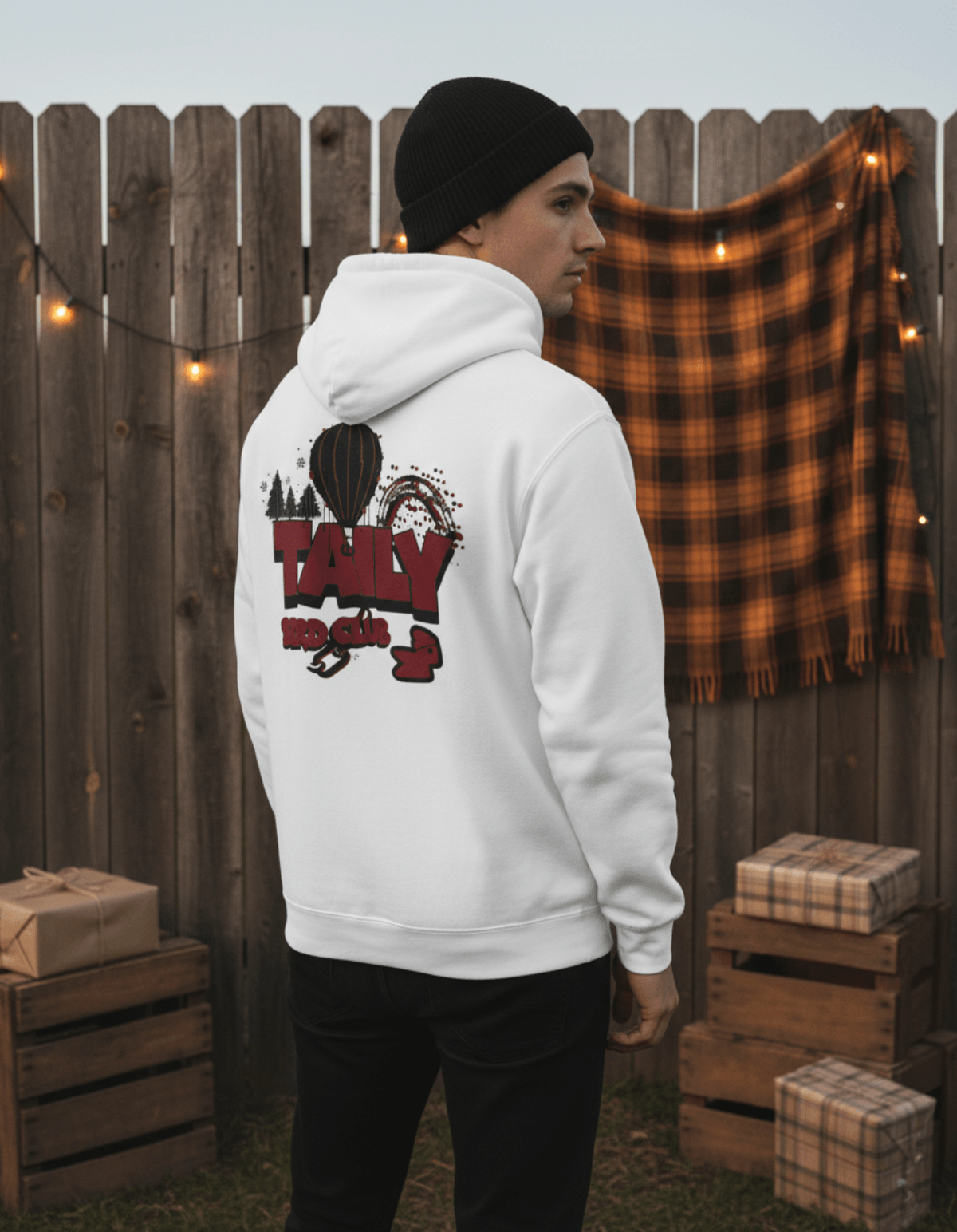 Taily Bird Parkland Hoodie – White, featured on a model showcasing its back graphic in a cozy outdoor setting.