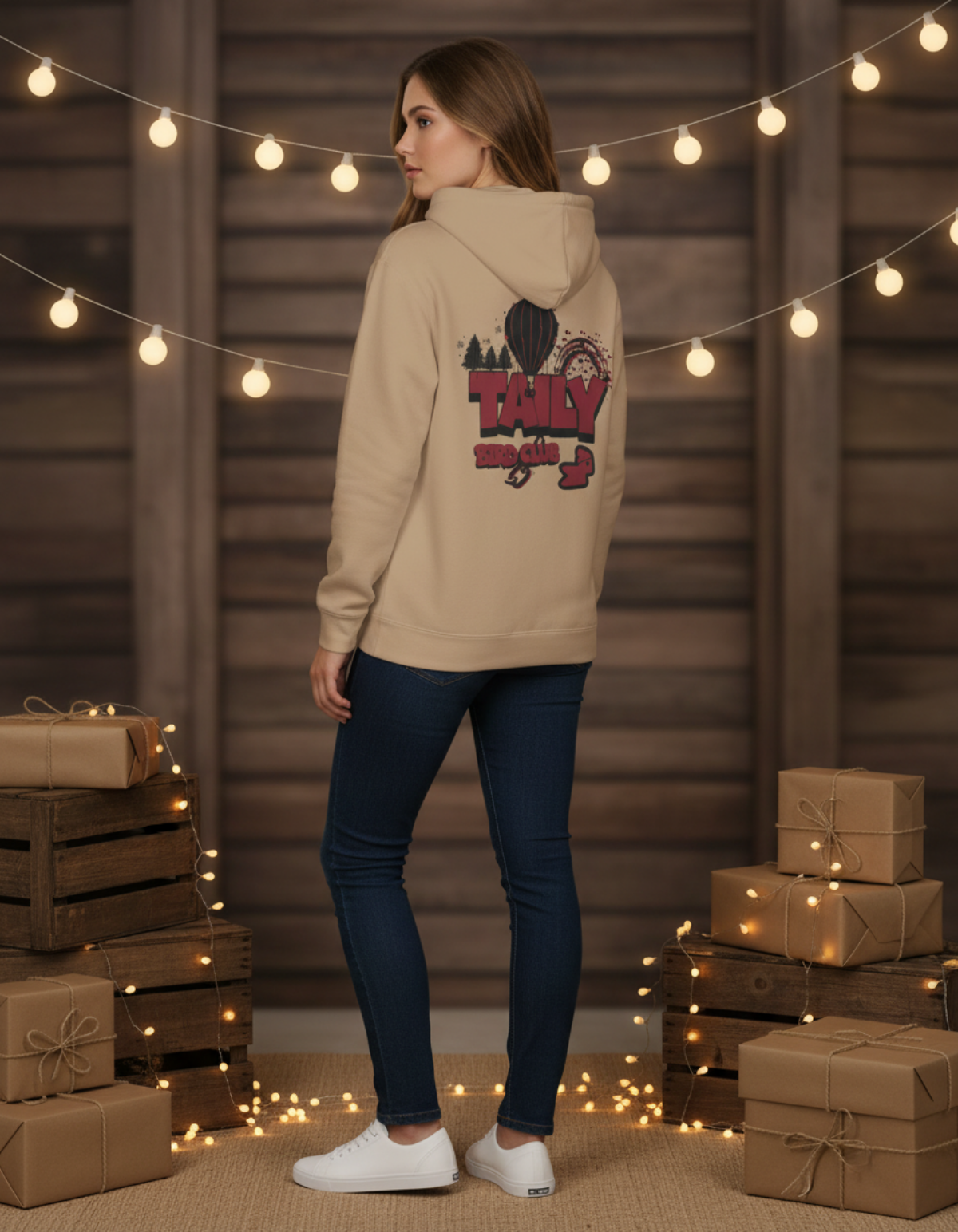 Taily Bird Parkland Hoodie in Sandstone color, showcasing back design in a cozy setting with decorative lights.