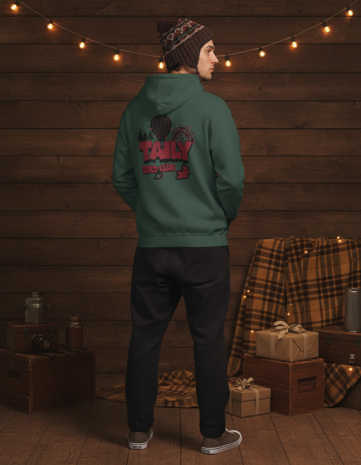 Model wearing Taily Bird Parkland Hoodie in Alpine Green, showcasing the expressive back graphic.