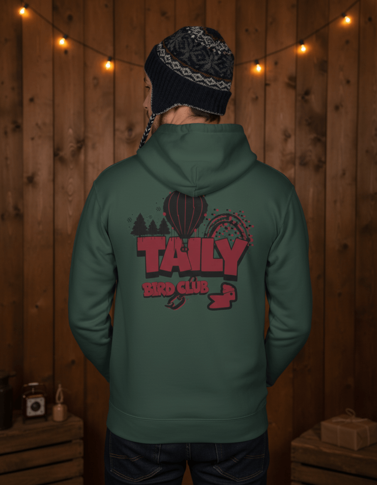 Back view of a person wearing the Taily Bird Parkland Hoodie – Alpine Green showcasing the colorful graphic design.
