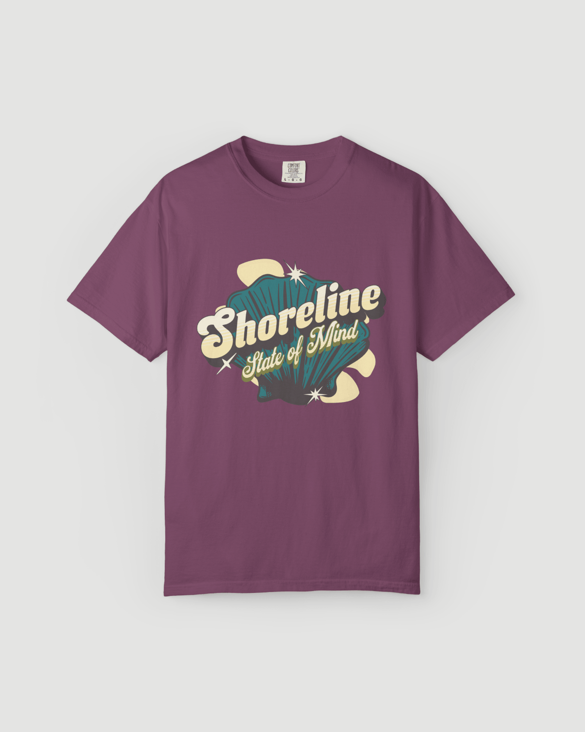 Shoreline State of Mind Tee – Berry featuring a vintage seashell graphic on a berry-colored heavyweight tee.