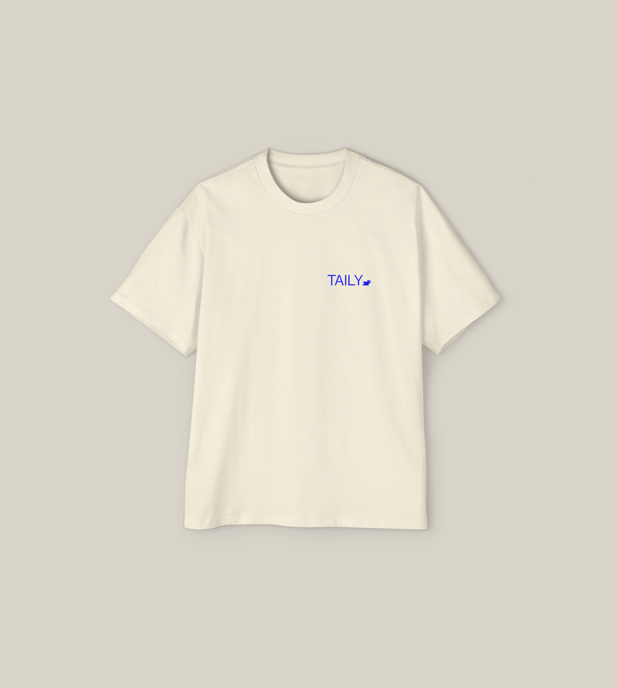 Create Impact oversized tee in cream with blue 'TAILY' logo, perfect for inner growth and transformation.