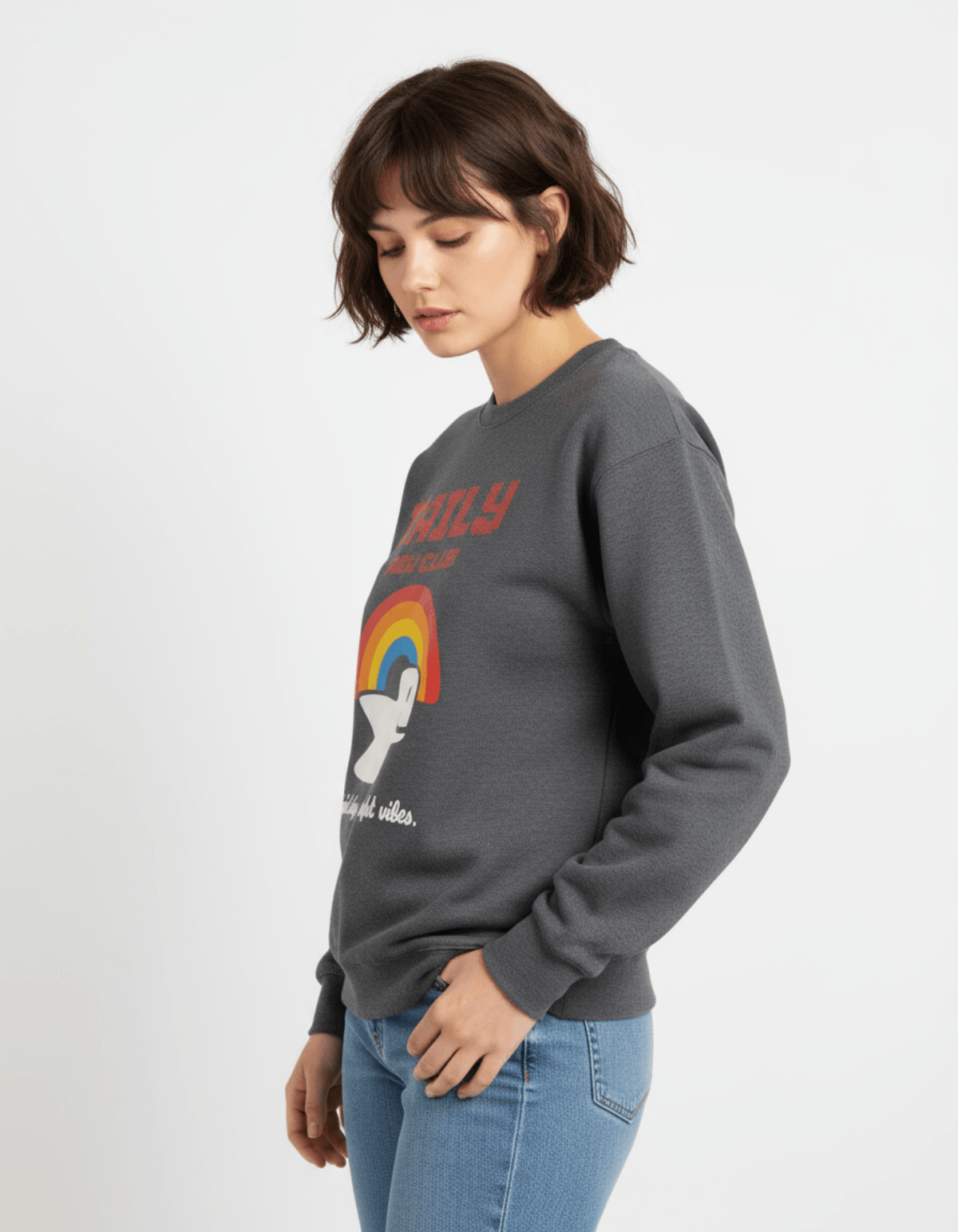 Taily RBW Club Sweatshirt – Charcoal Heather worn by a model, featuring rainbow graphics and optimistic text.