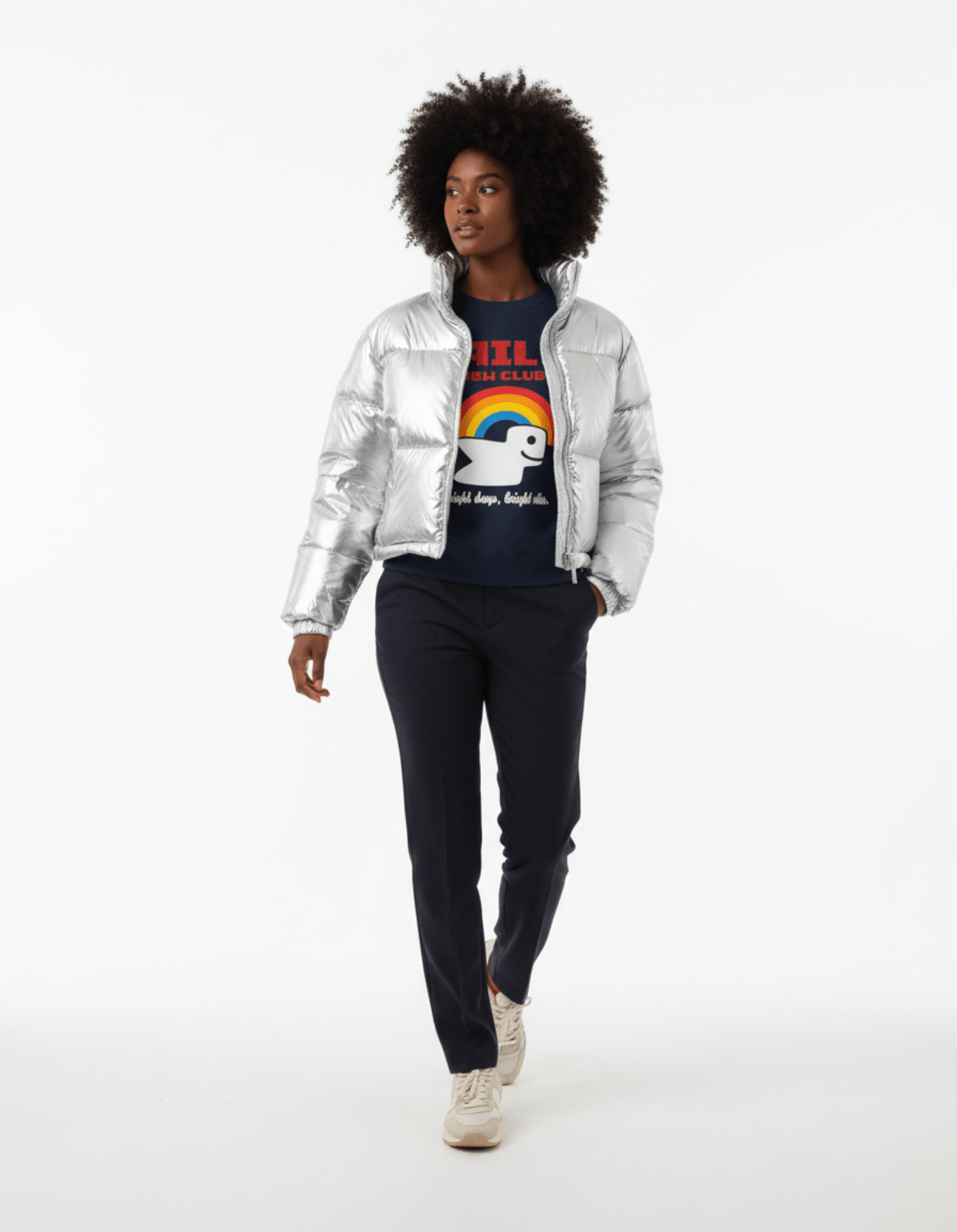 Model wearing Taily RBW Club Sweatshirt – Navy with a silver puffer jacket and navy pants.
