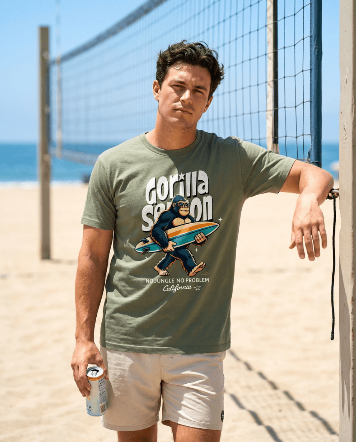 Gorilla Season Surf Tee – Sage worn by a man on the beach, showcasing California surf graphic and relaxed style.