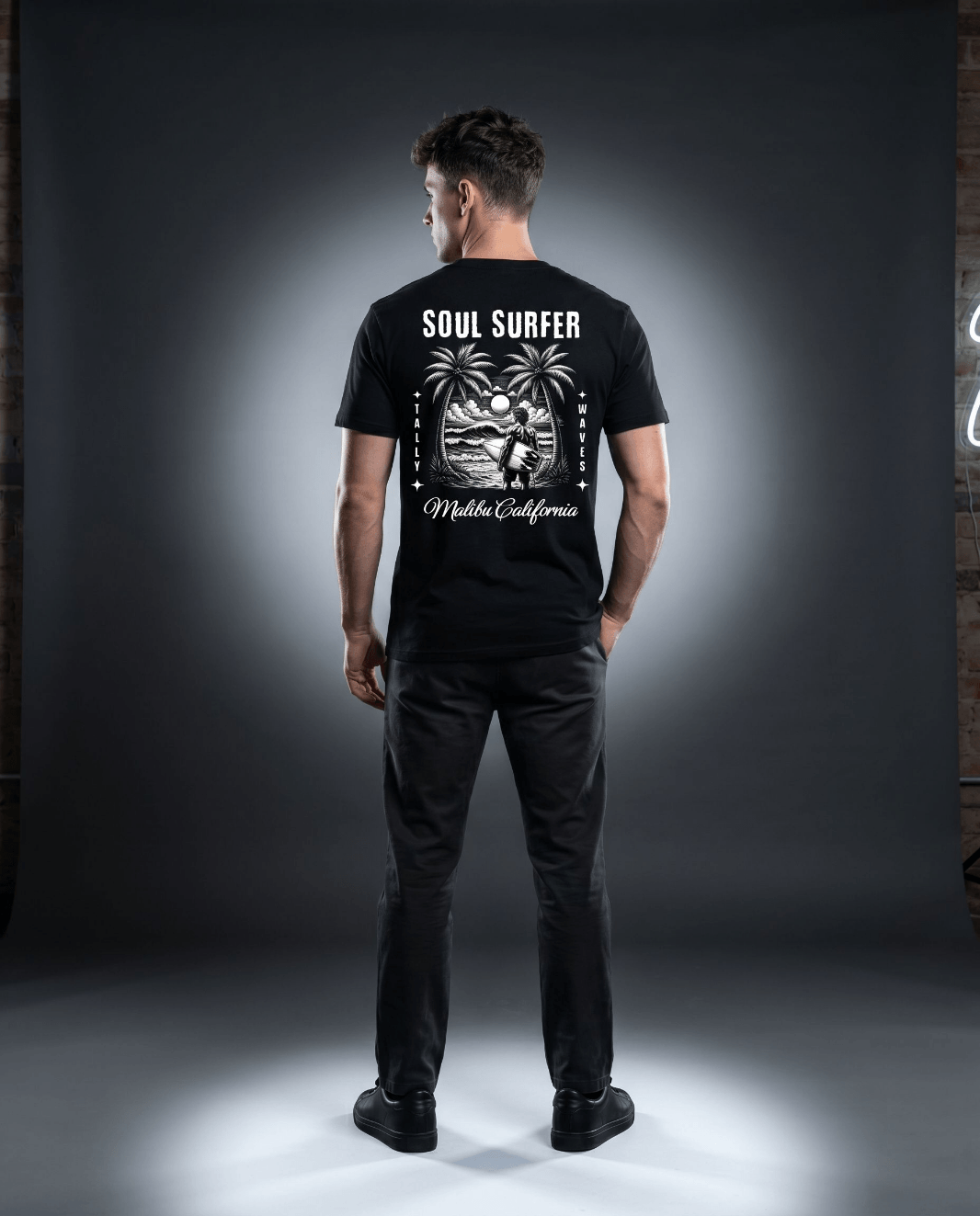 Model wearing Soul Surfer Malibu Tee featuring an engraved graphic and palm trees on the back.