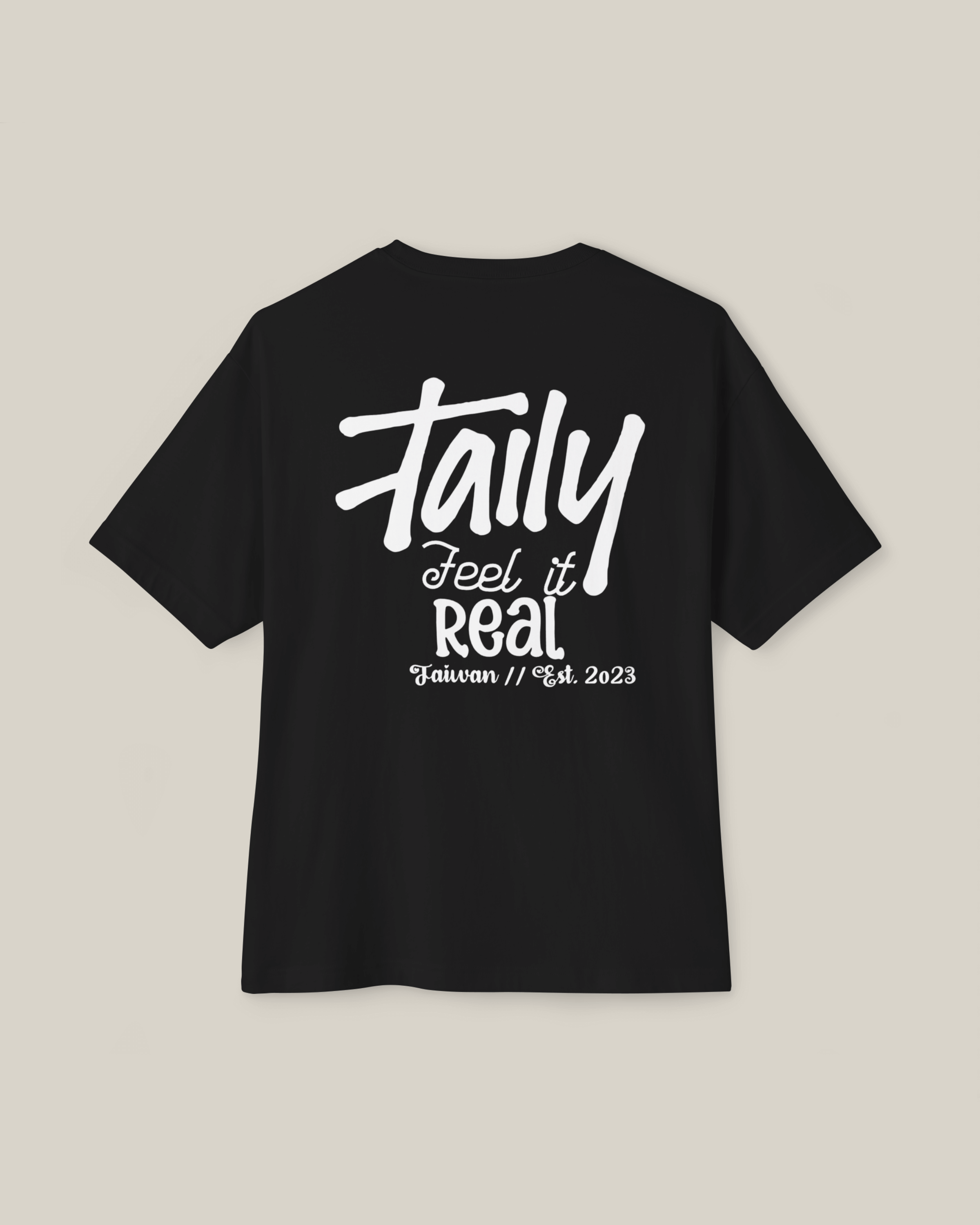 Taily Feel It Real Boxy Tee in black with bold lettering, showcasing streetwear boxy t-shirt style.