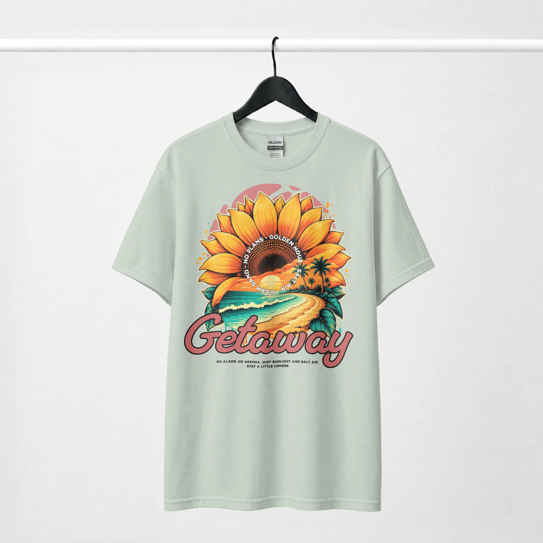 Getaway Sunflower Beach Tee – Bay featuring a vibrant sunflower and coastal scenery design.