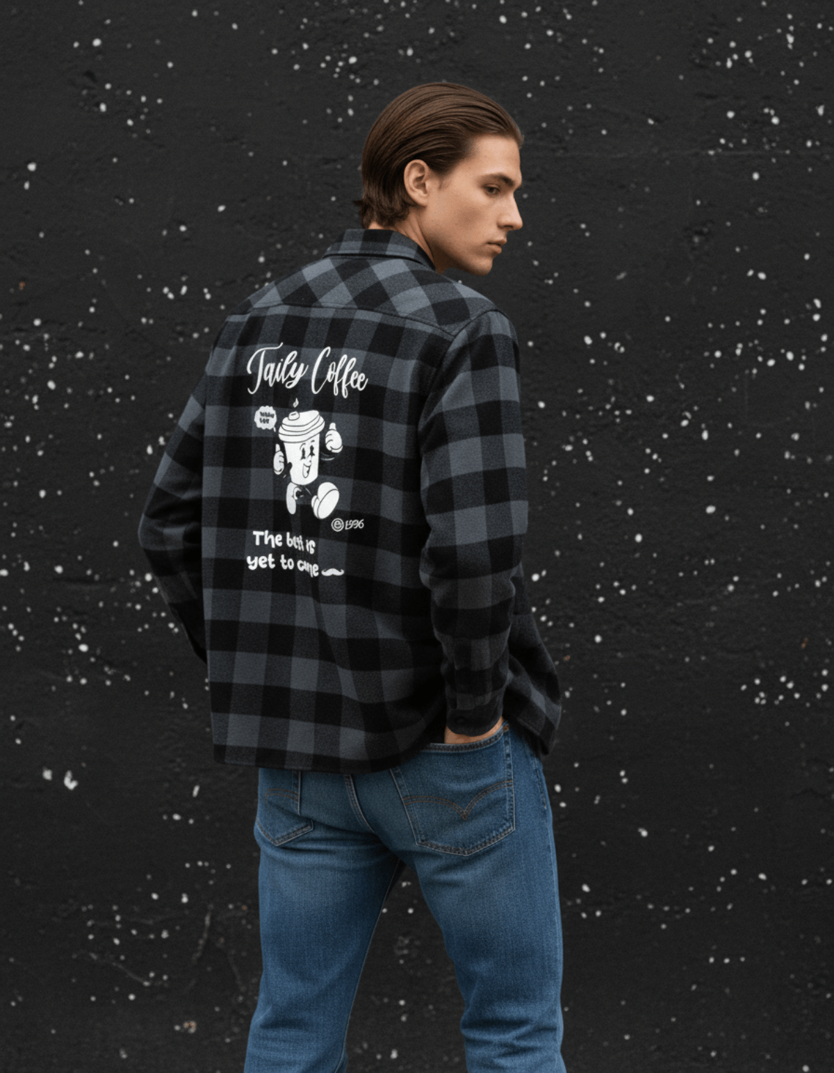 Taily Coffee flannel shirt in Charcoal Heather worn by a model against a textured wall showcasing playful café graphics.