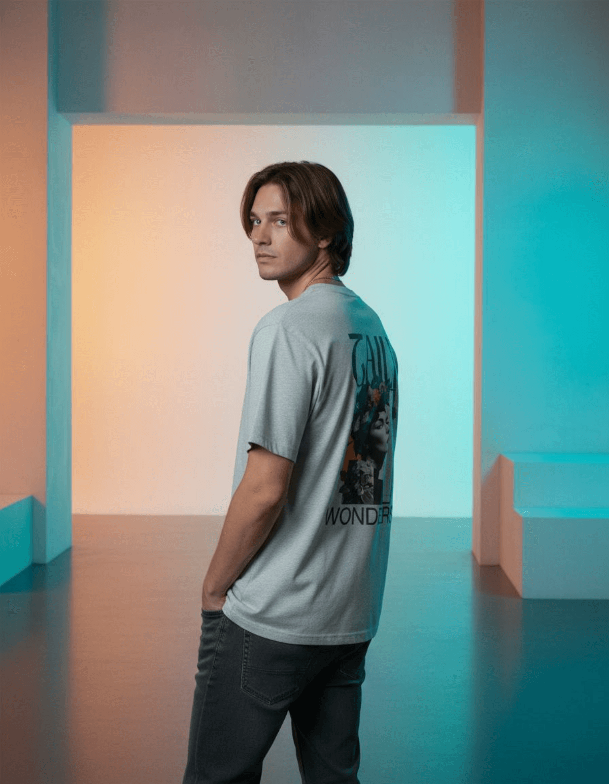 Model wearing Taily Wonders vintage boxy t-shirt in athletic gray showcasing artistic back design.