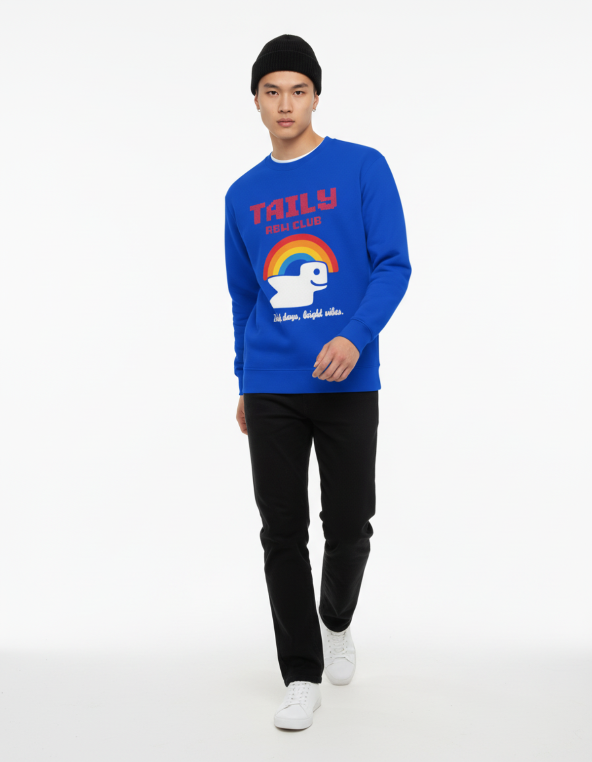 Model wearing Taily RBW Club sweatshirt in royal blue featuring rainbow graphic and bird design.