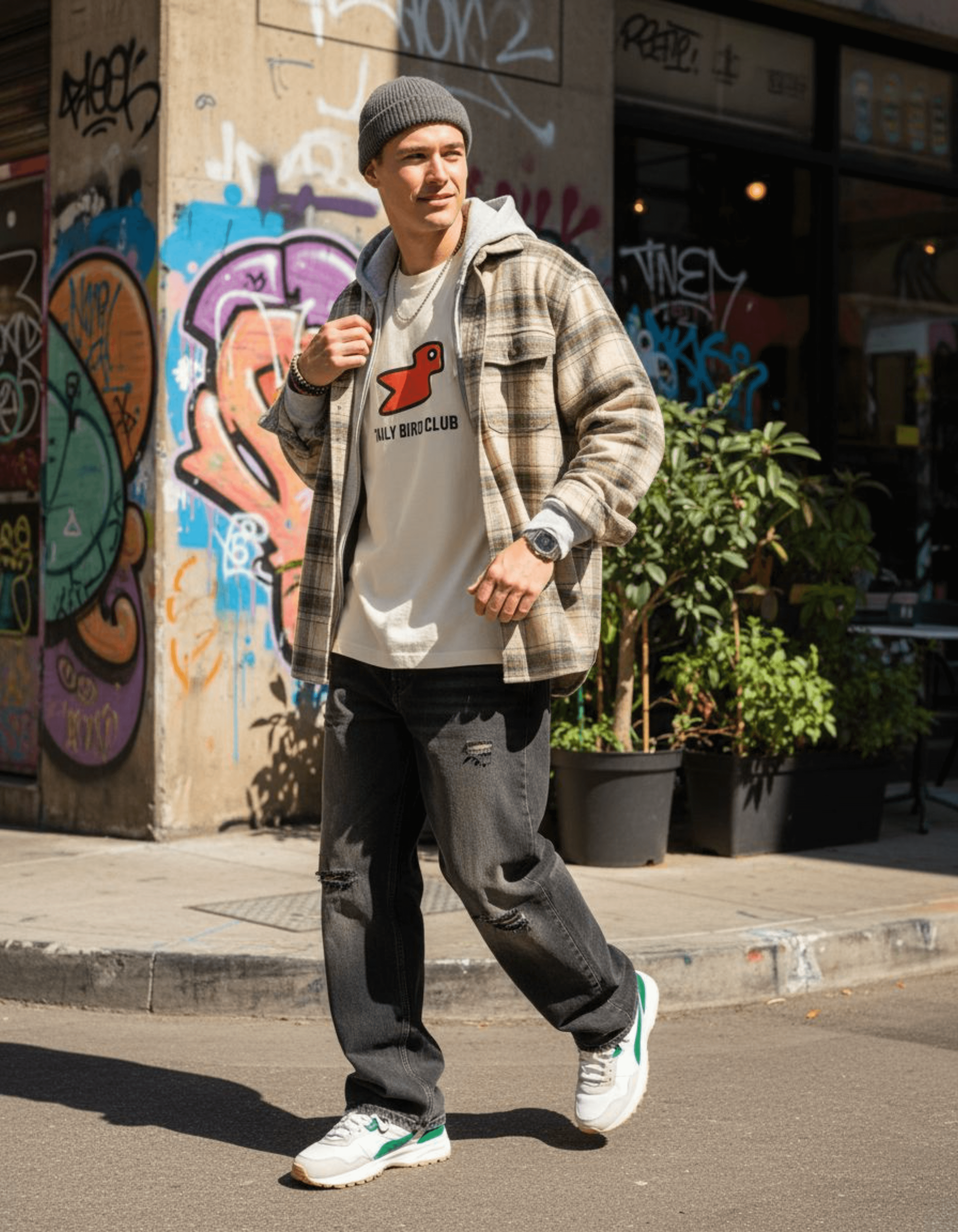 Style shot of a man wearing Taily Bird Club Streetwear Boxy T-Shirt with bird design in a urban setting.