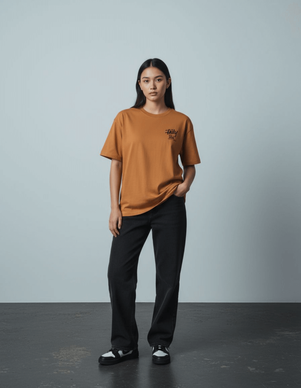 Model wearing Taily Feel It Real Boxy Tee in toast, showcasing a streetwear boxy t-shirt style.