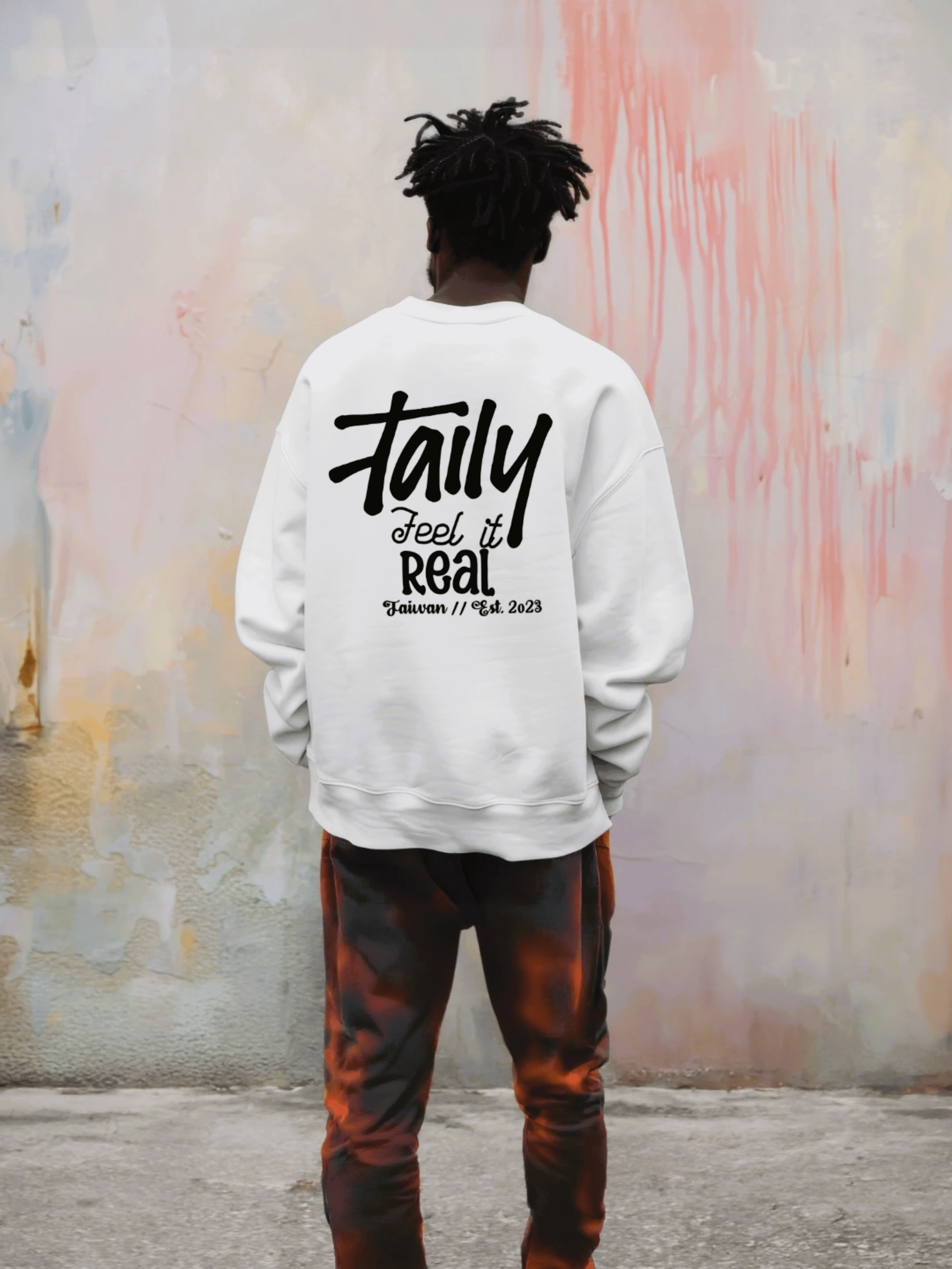 White Taily Feel It Real sweatshirt with logo on chest and bold lettering on the back, offering streetwear style.