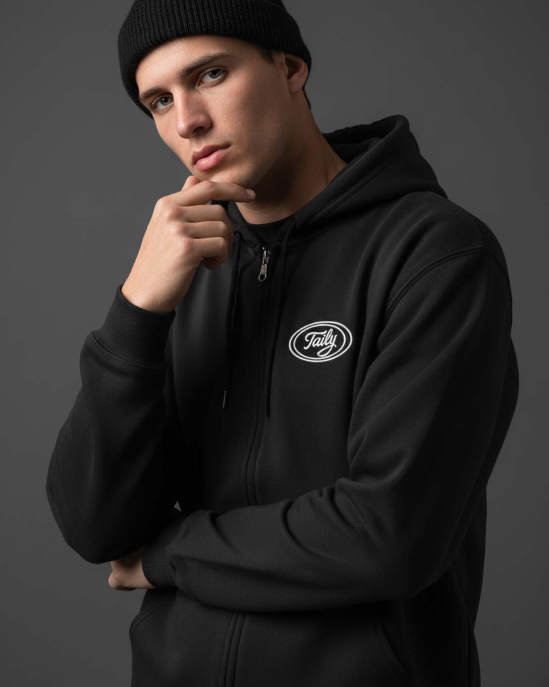 Model wearing Taily Zip Hoodie in black, showcasing classic embroidered streetwear style.