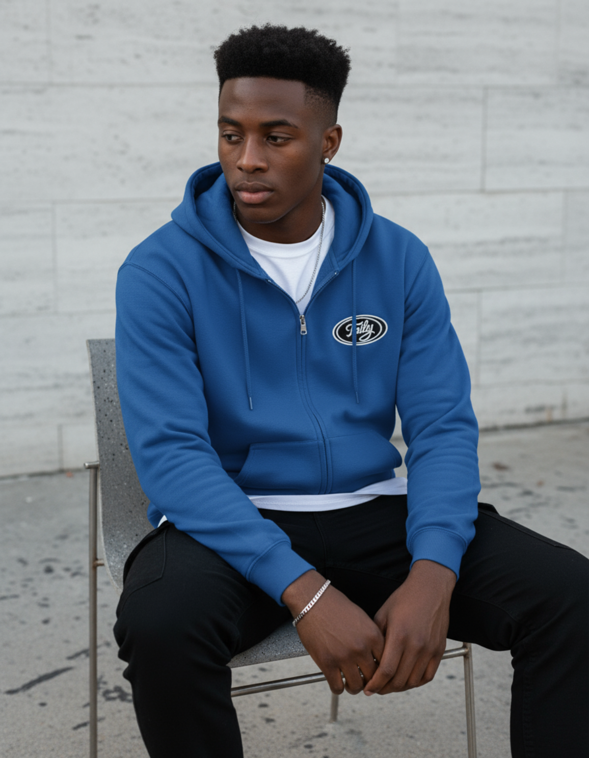 Taily Zip Hoodie – Classic Embroidered Streetwear in Royal, worn by a model sitting casually.
