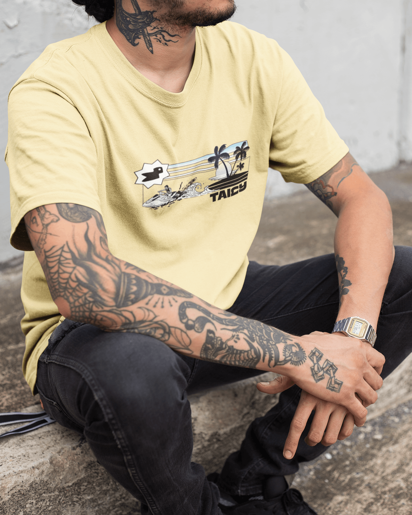 Man wearing Taily Summer Souvenir Tee with jet ski splash scene and palm trees, showcasing a stylish summer vibe.