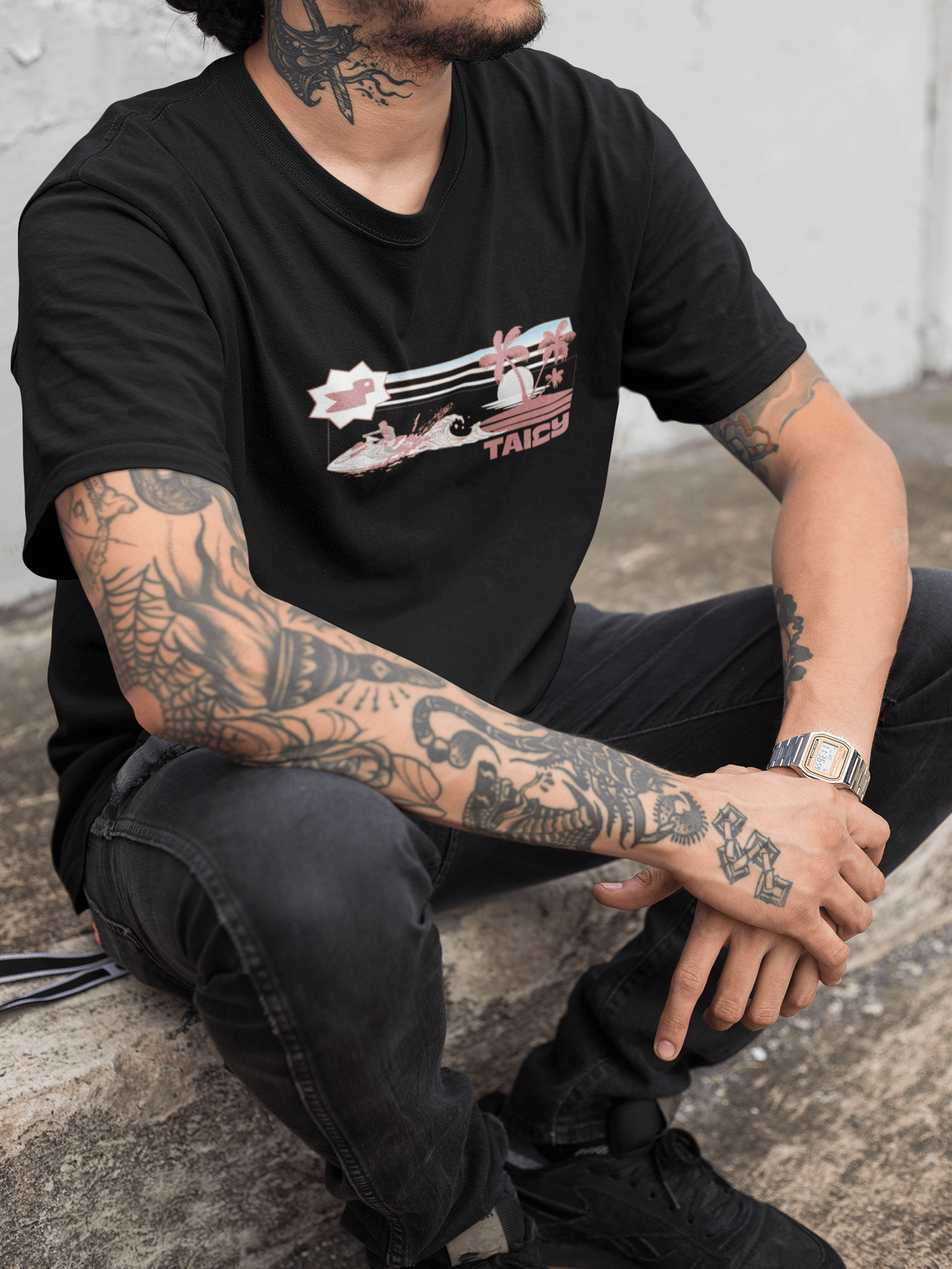 Model wearing Taily Jet Splash black graphic t-shirt featuring jet ski and island print, showcasing streetwear style.