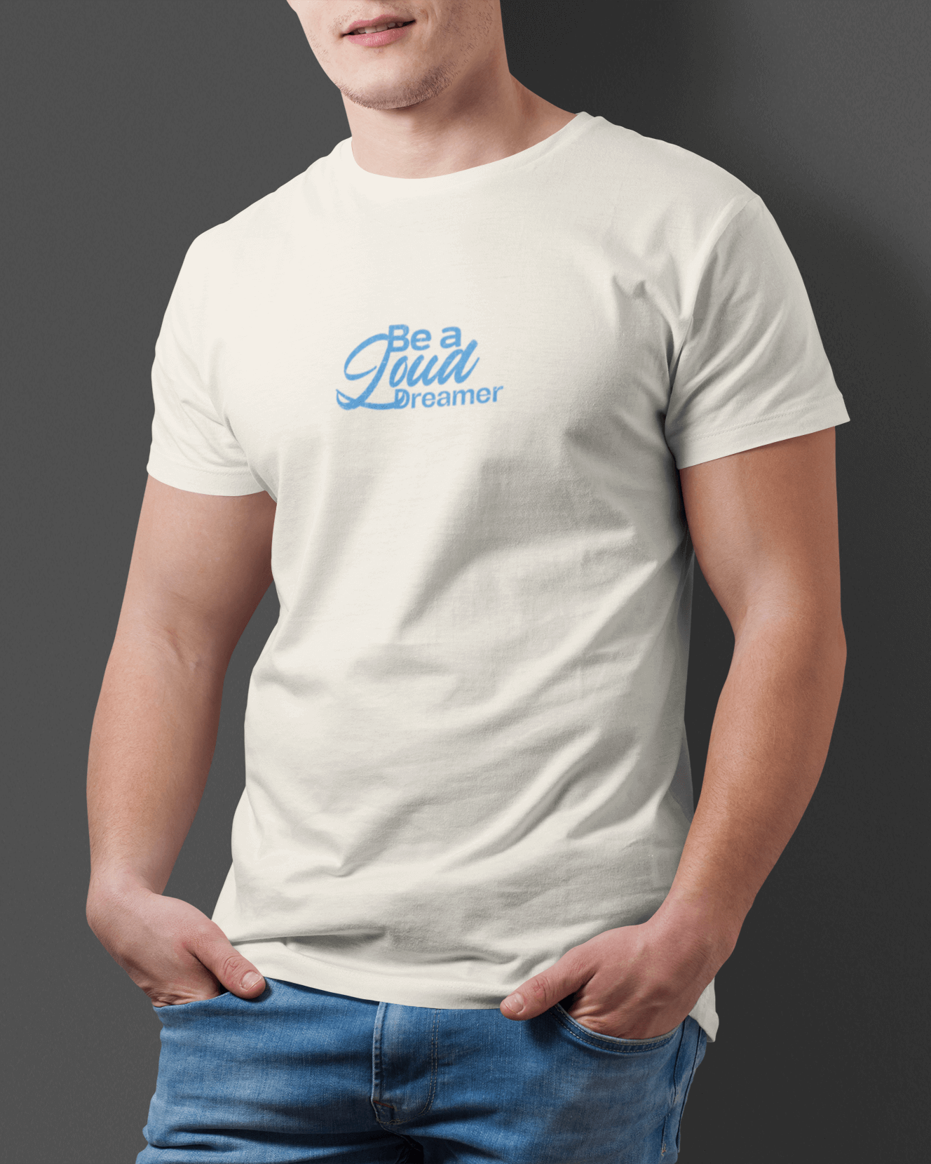 Model wearing Taily Loud Dreamer graphic t-shirt in ivory with blue lettering for streetwear style.