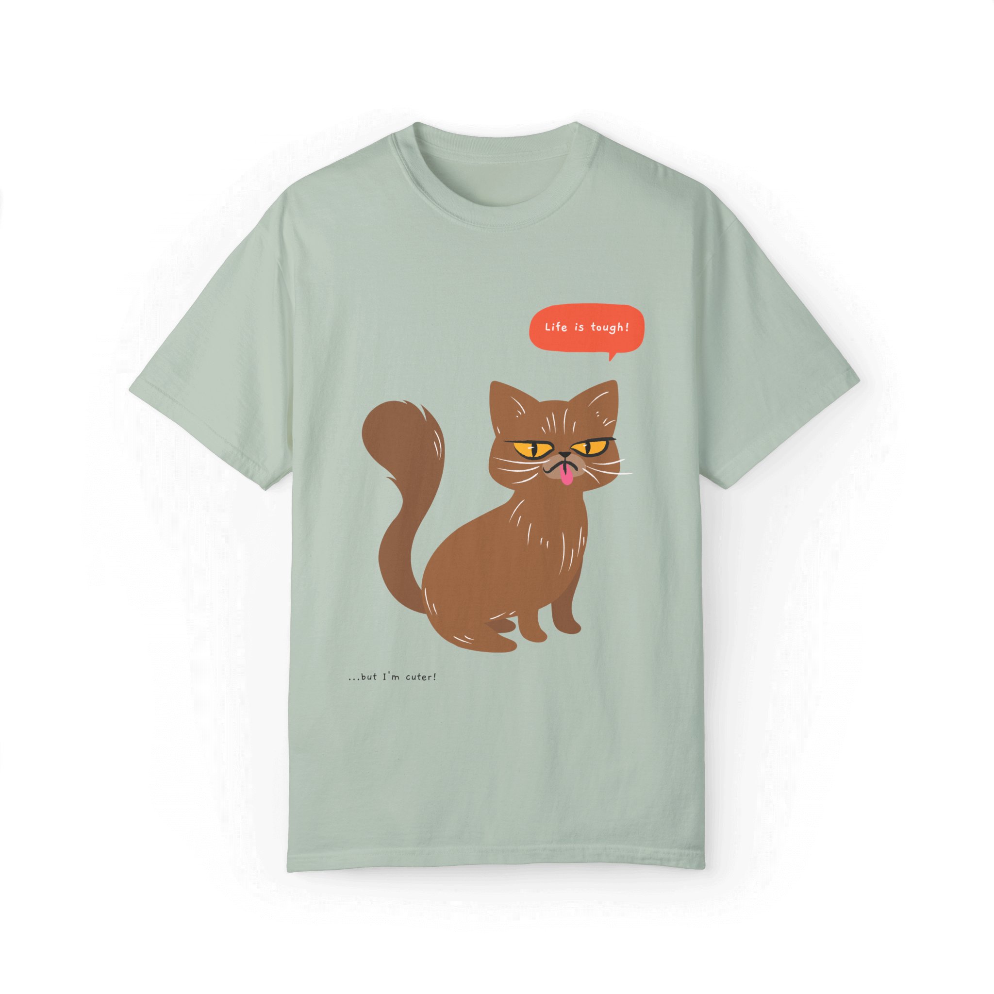 Light green T-shirt featuring a brown cat illustration with the phrase 'Life is tough!' and a humorous note '...but I'm cuter!