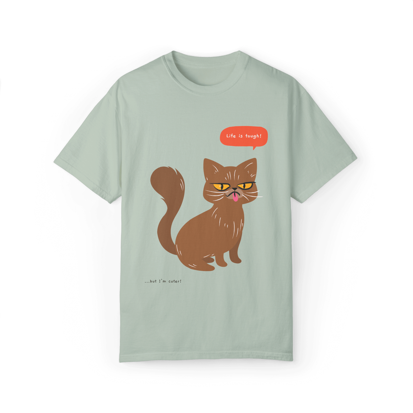 Light green T-shirt featuring a brown cat illustration with the phrase 'Life is tough!' and a humorous note '...but I'm cuter!