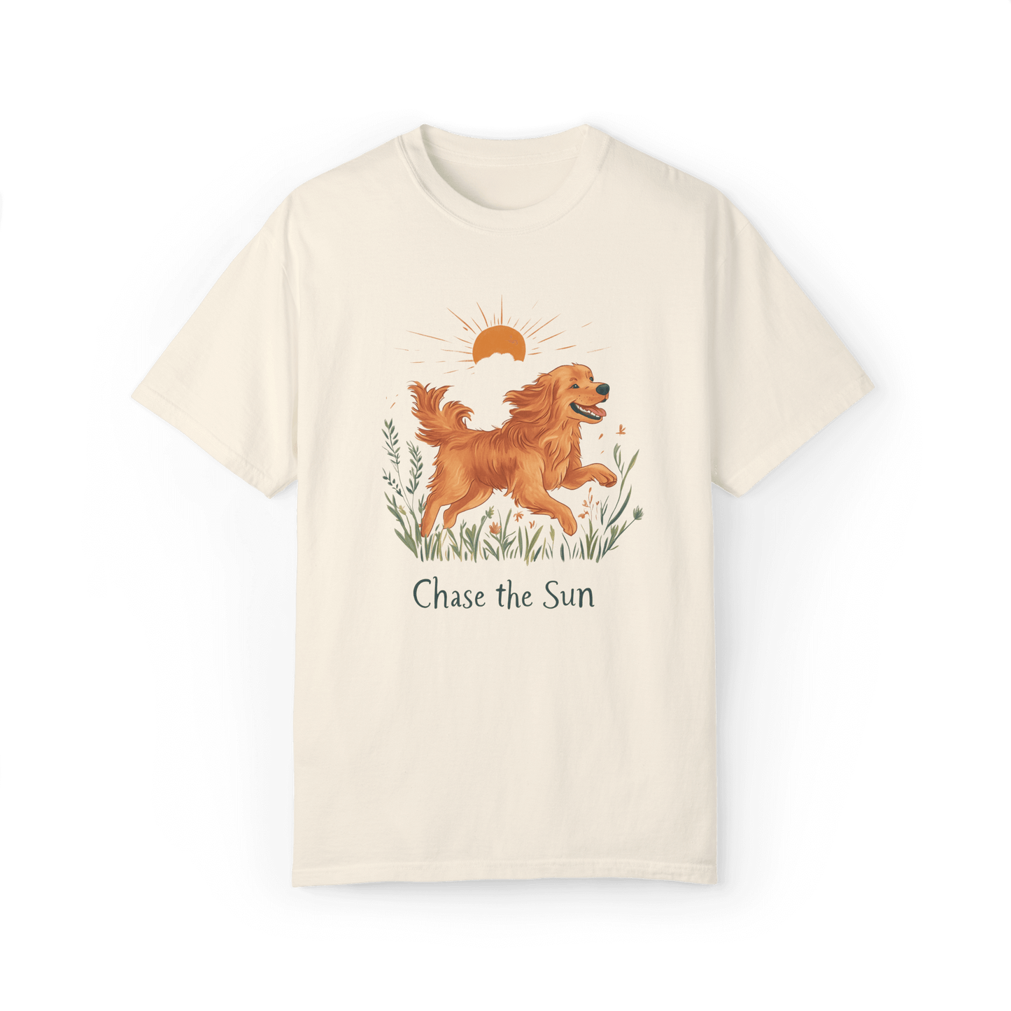 A off-white T-shirt featuring an illustration of a running golden retriever with a warm sun and natural wildflowers in the background, complemented by the text "Chase the Sun," reflecting a lifestyle of freedom and sunshine.