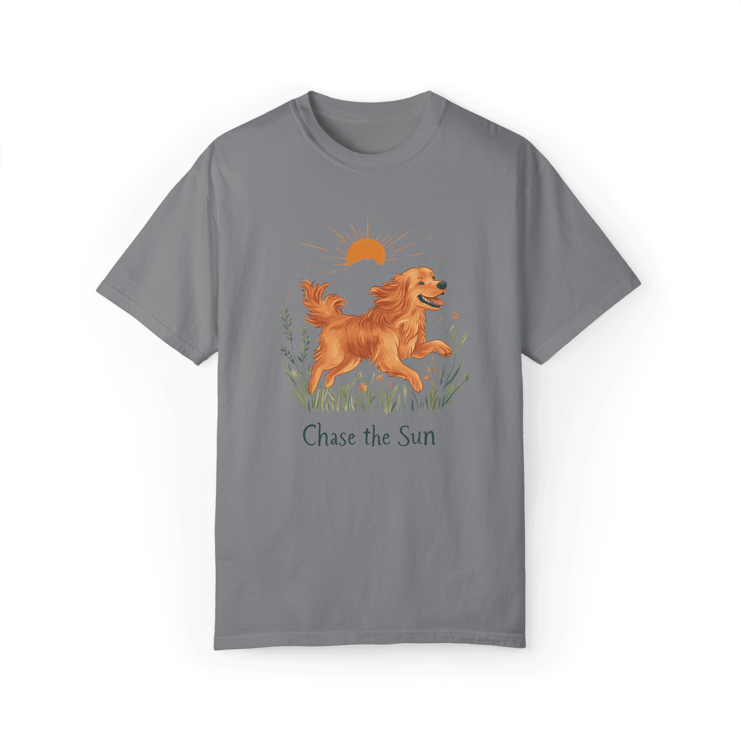 A gray T-shirt featuring an illustration of a running golden retriever with a warm sun and natural wildflowers in the background, complemented by the text "Chase the Sun," reflecting a lifestyle of freedom and sunshine.