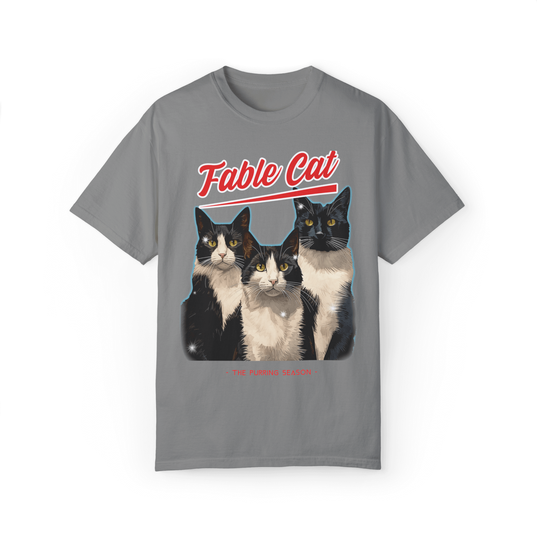 Gray T-shirt featuring an illustration of three tuxedo cats, with bold red text 'Fable Cat' above and the subtitle 'The Purring Season' below.