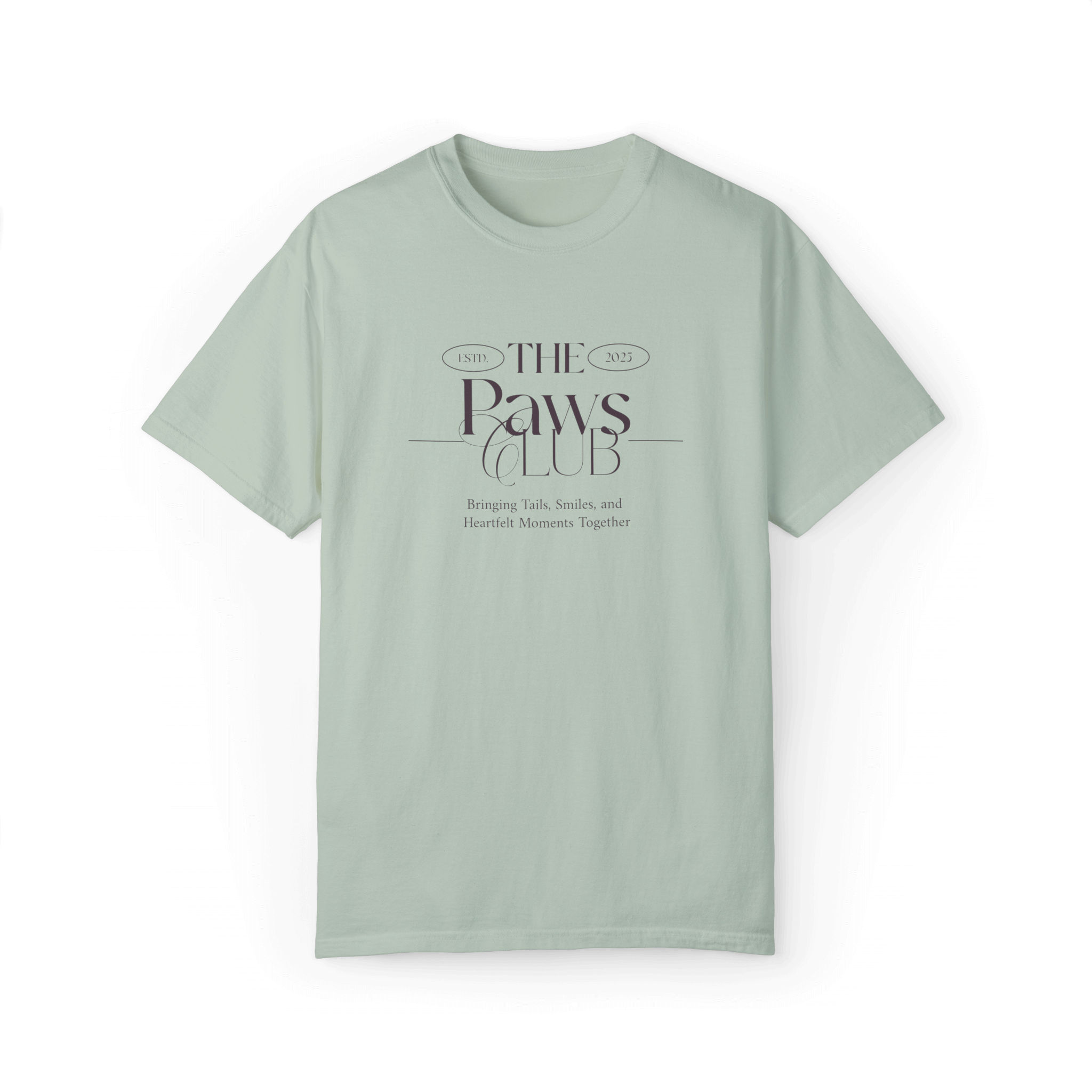 Light green T-shirt featuring 'The Paws Club' logo in refined typography with the tagline 'Bringing Tails, Smiles, and Heartfelt Moments Together,' showcasing an elegant and minimalist design.