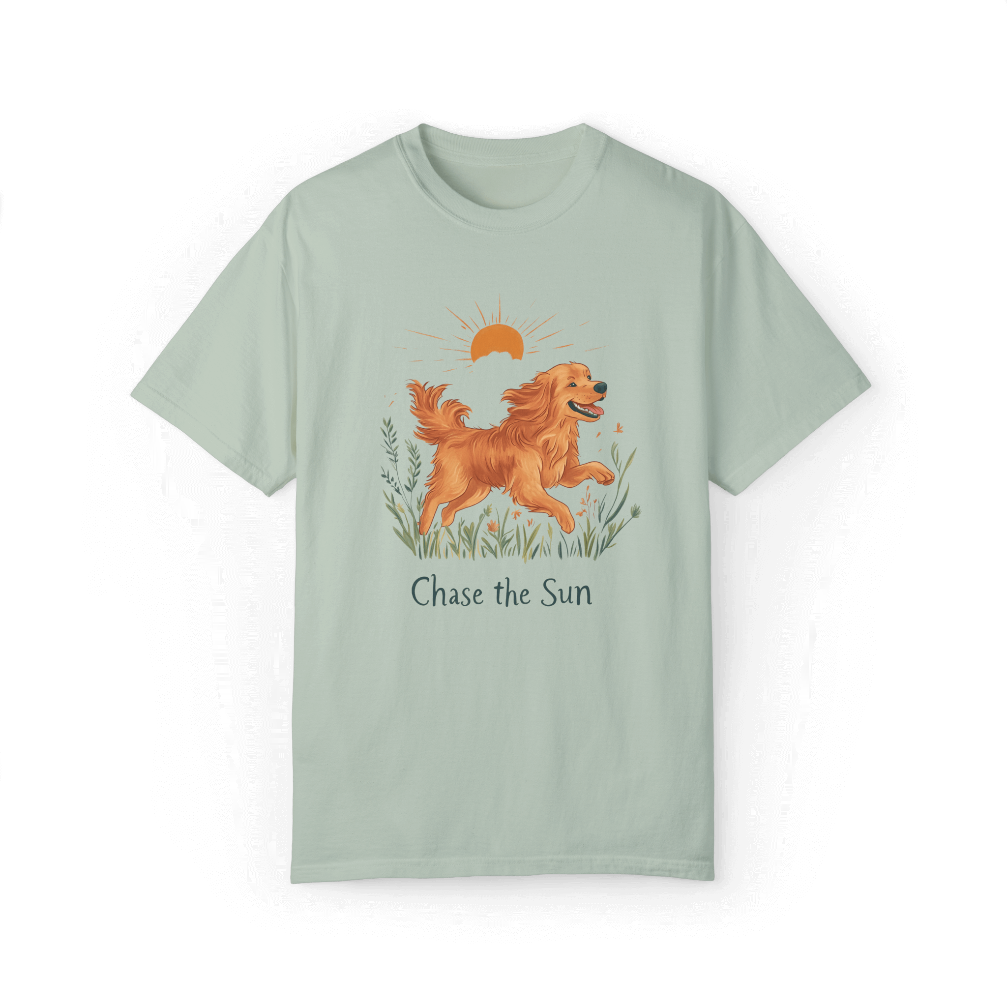 A light green T-shirt featuring an illustration of a running golden retriever with a warm sun and natural wildflowers in the background, complemented by the text 