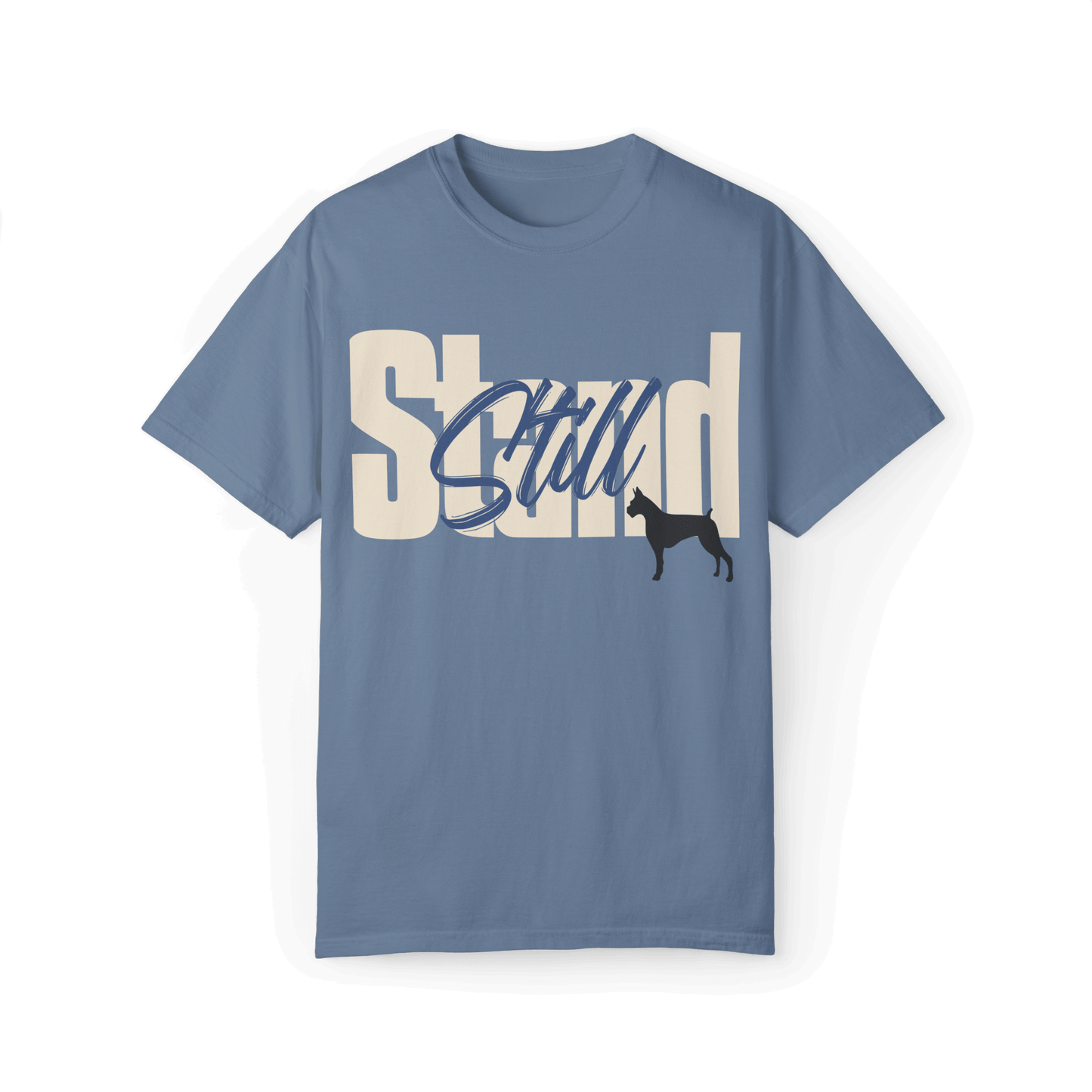 Light blue T-shirt featuring bold typography reading 'Stand Still' in white and blue, with a black dog silhouette integrated into the design.