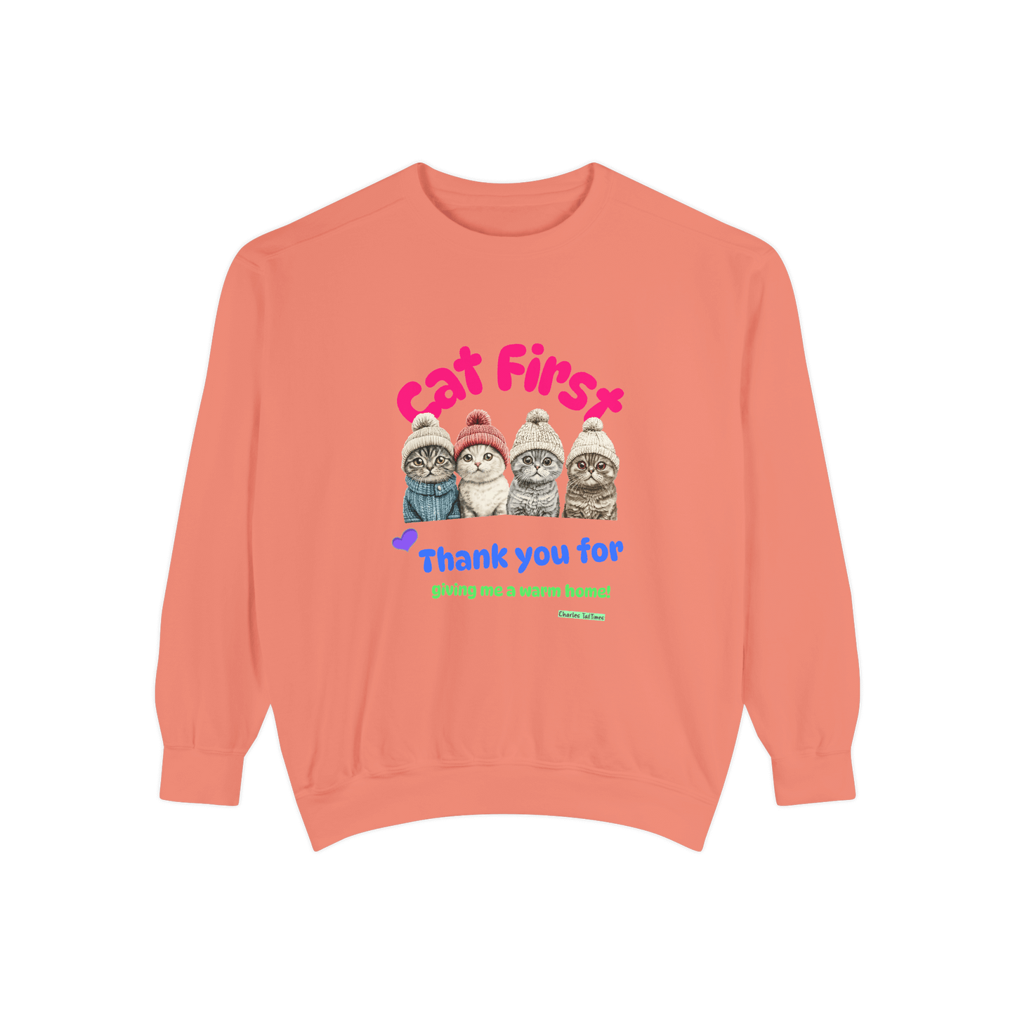 Coral sweatshirt featuring an illustration of four Scottish Fold cats wearing knitted hats, with colorful text 'Cat First' and 'Thank you for giving me a warm home!' underneath.