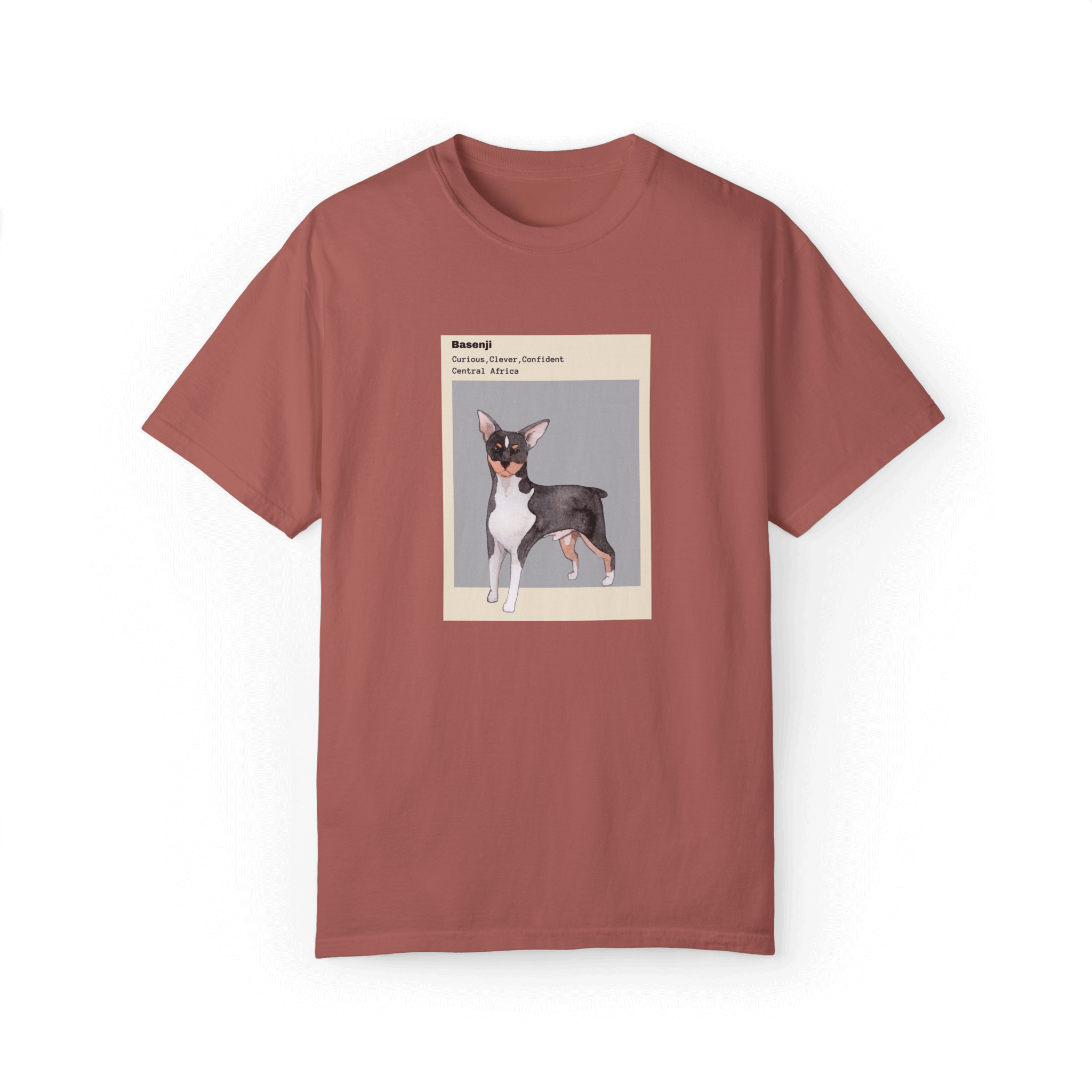 Dusty rose T-shirt featuring a watercolor illustration of a Basenji dog with text describing its traits: 'Curious, Clever, Confident,' and its origin, 'Central Africa,' framed in minimalist beige and gray design.