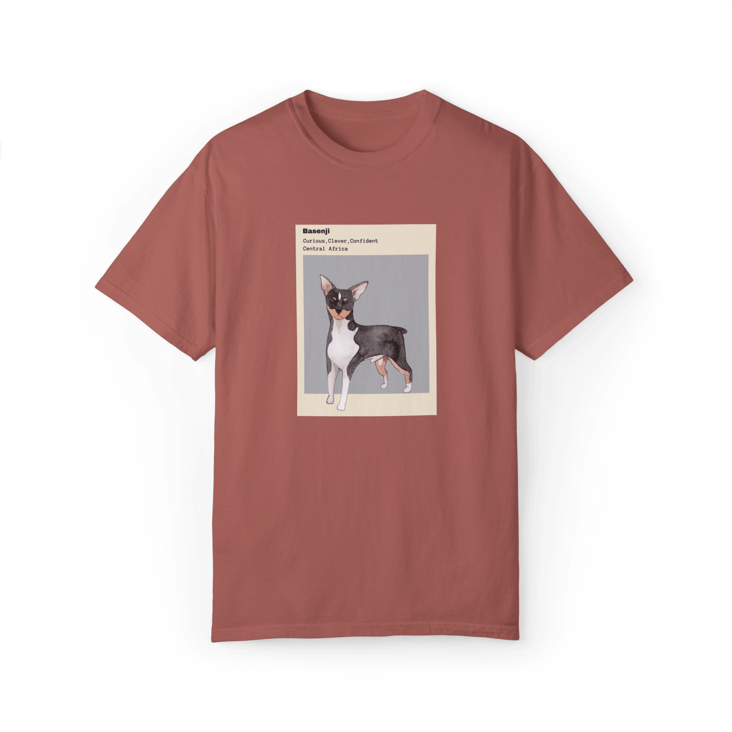 Dusty rose T-shirt featuring a watercolor illustration of a Basenji dog with text describing its traits: 'Curious, Clever, Confident,' and its origin, 'Central Africa,' framed in minimalist beige and gray design.