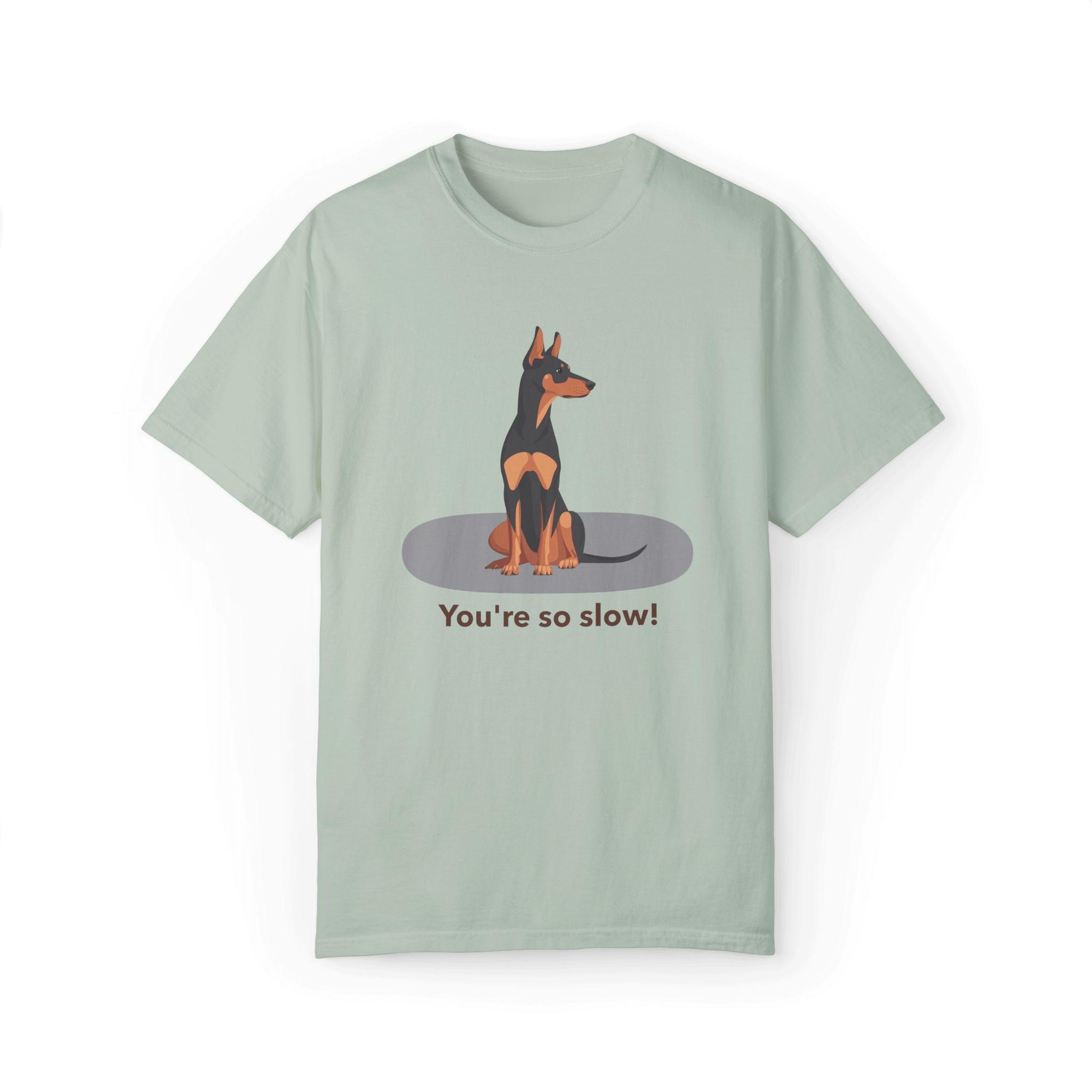 A mint green T-shirt featuring a cartoon Doberman illustration with the humorous text 