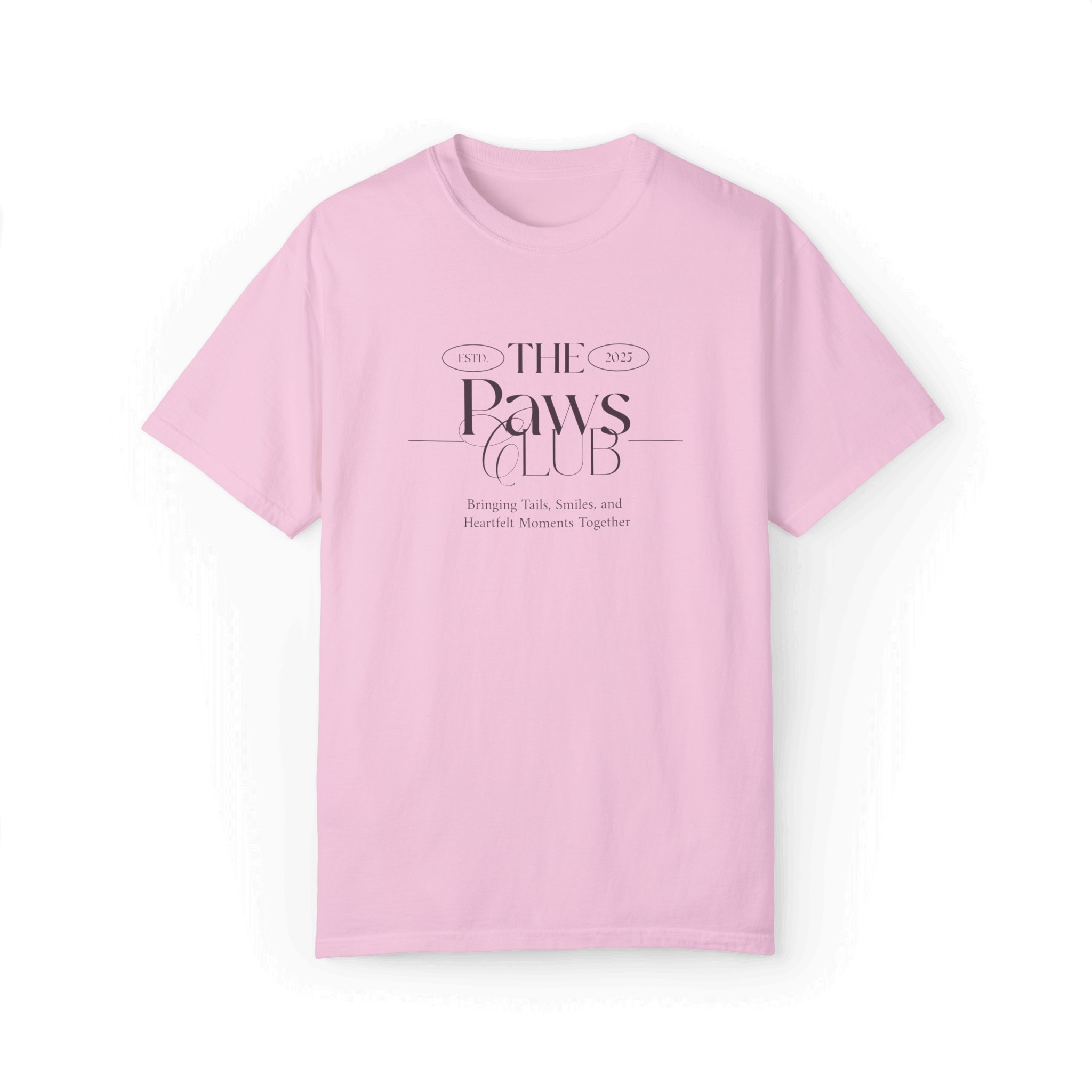 Light pink T-shirt featuring 'The Paws Club' logo in elegant typography with the tagline 'Bringing Tails, Smiles, and Heartfelt Moments Together,' showcasing a minimalist and stylish design.