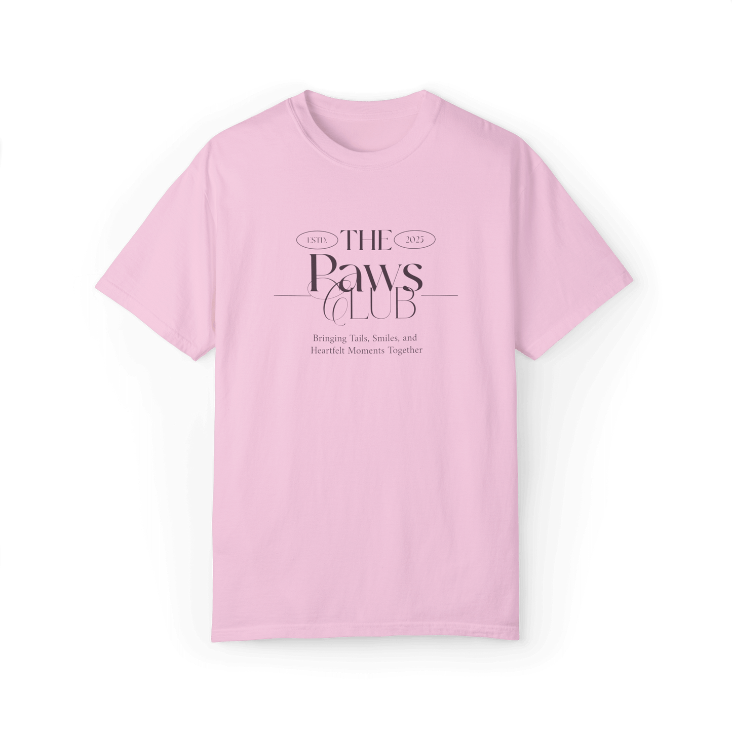 Light pink T-shirt featuring 'The Paws Club' logo in elegant typography with the tagline 'Bringing Tails, Smiles, and Heartfelt Moments Together,' showcasing a minimalist and stylish design.