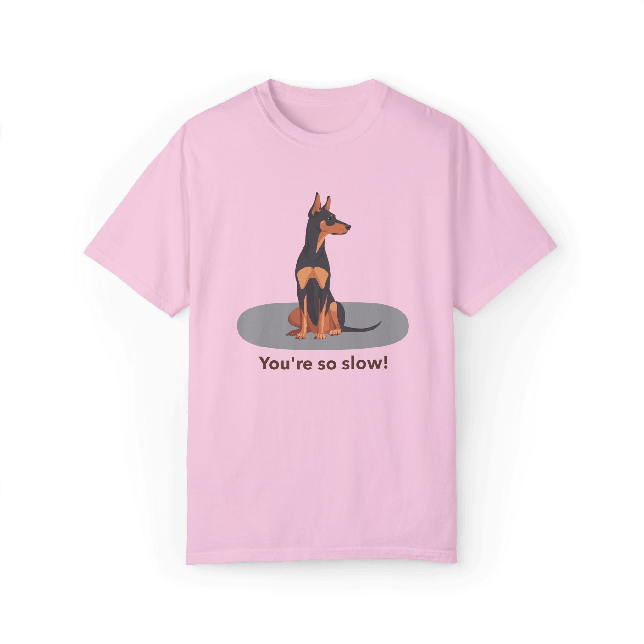 A pink T-shirt featuring a cartoon Doberman illustration with the humorous text 