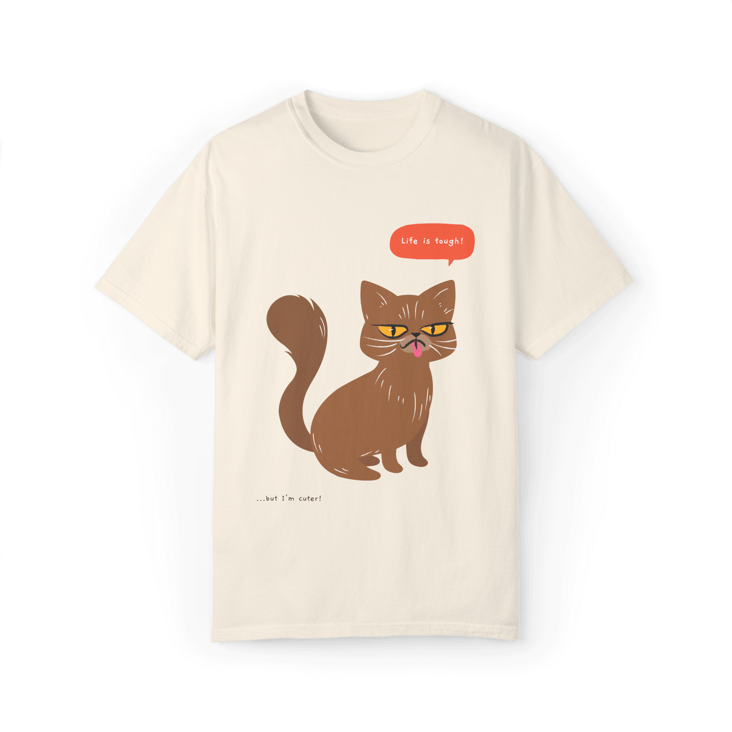 Beige T-shirt featuring a brown cat illustration with the phrase 'Life is tough!' and a humorous note '...but I'm cuter!