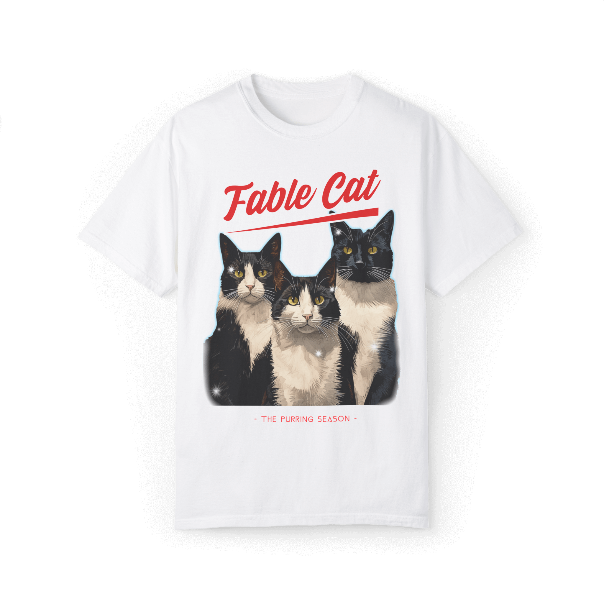 White T-shirt with an illustration of three tuxedo cats, featuring the text 'Fable Cat' in bold red typography above and the subtitle 'The Purring Season' below.